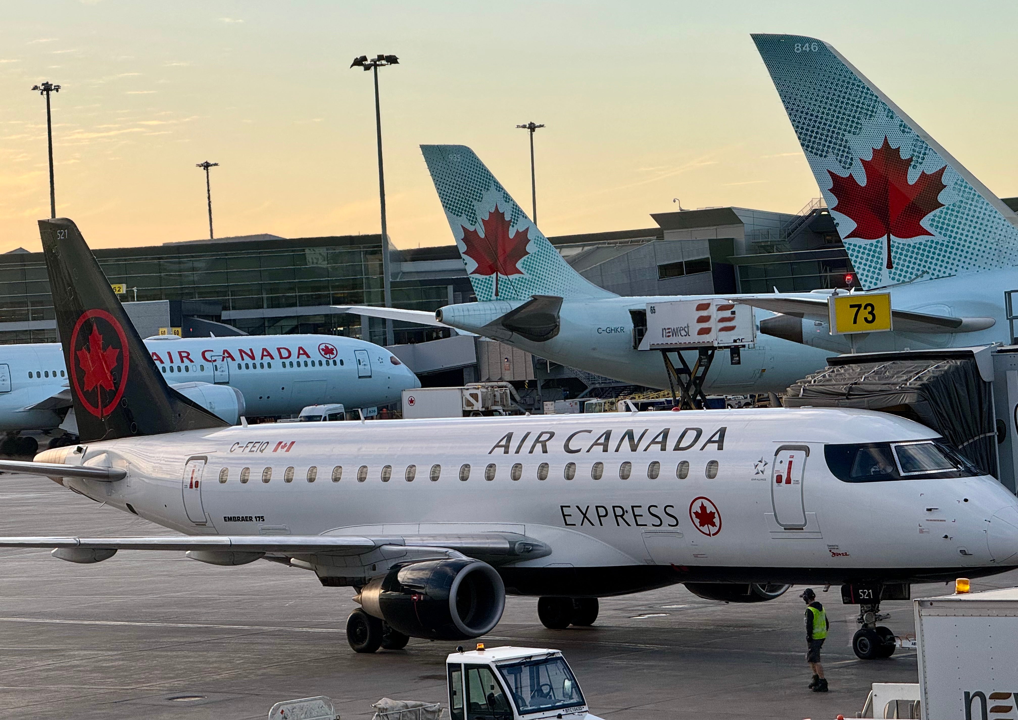 Air Canada planes are seen at the gates at Montreal International Airport