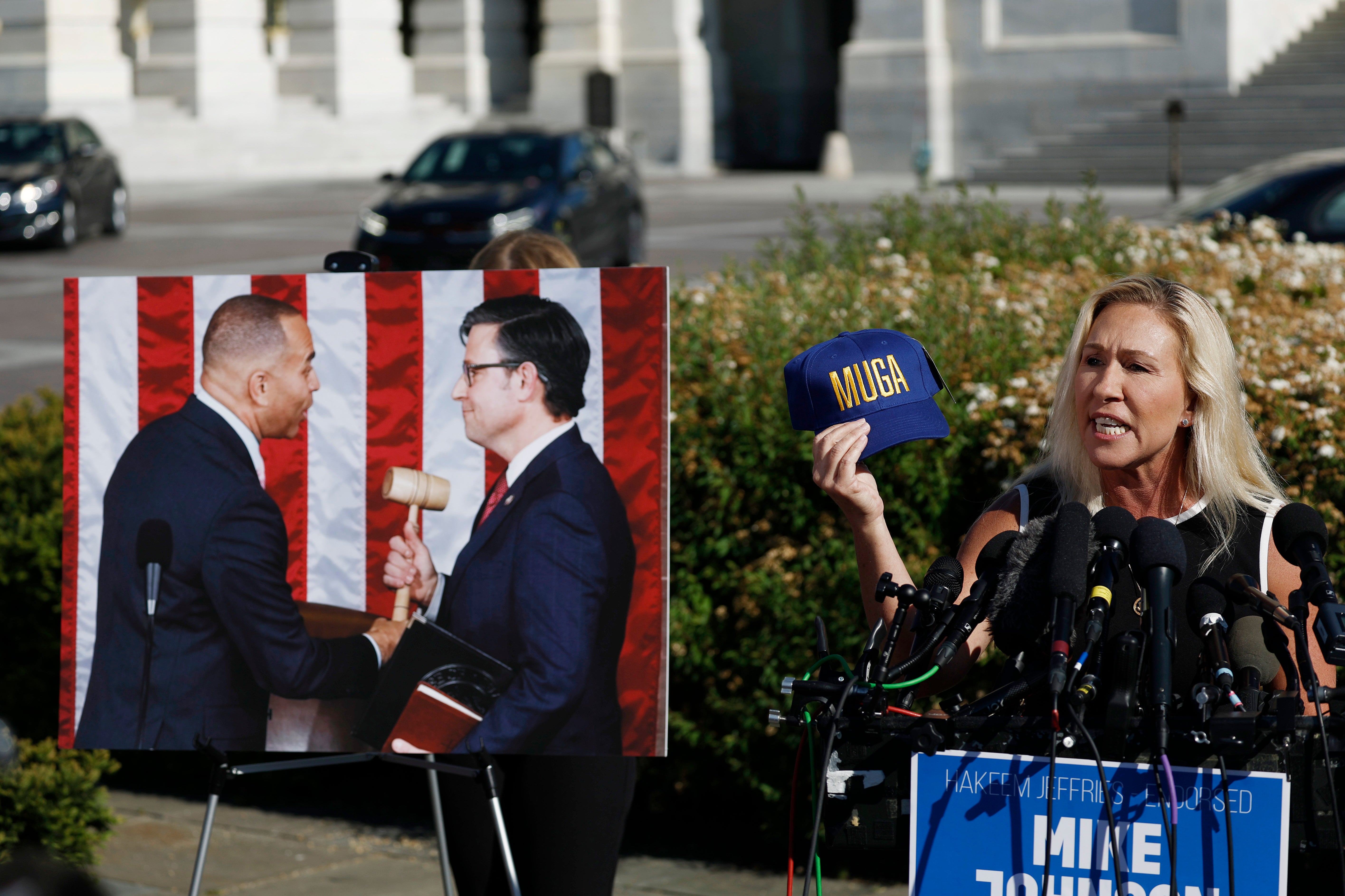 Georgia GOP Rep. Marjorie Taylor Greene holds up a hat that says “MUGA” or “Make Ukraine Great Again” as she speaks at a news conference alongside Rep. Thomas Massie (R-KY) at the Capitol on 1 May 2024 in Washington, DC