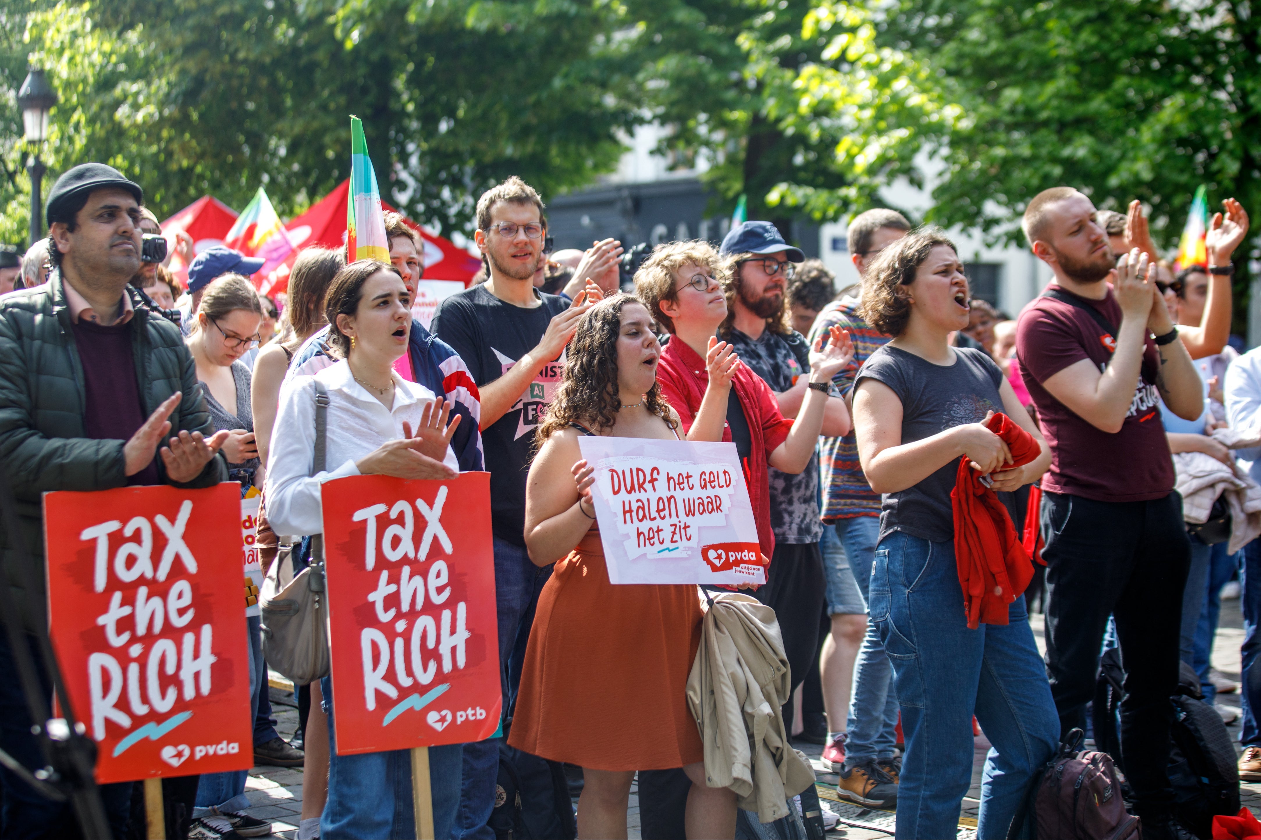 Demonstrators with ‘Tax the rich!’ placards in Brussels, Belgium, on International Workers’ Day 2024
