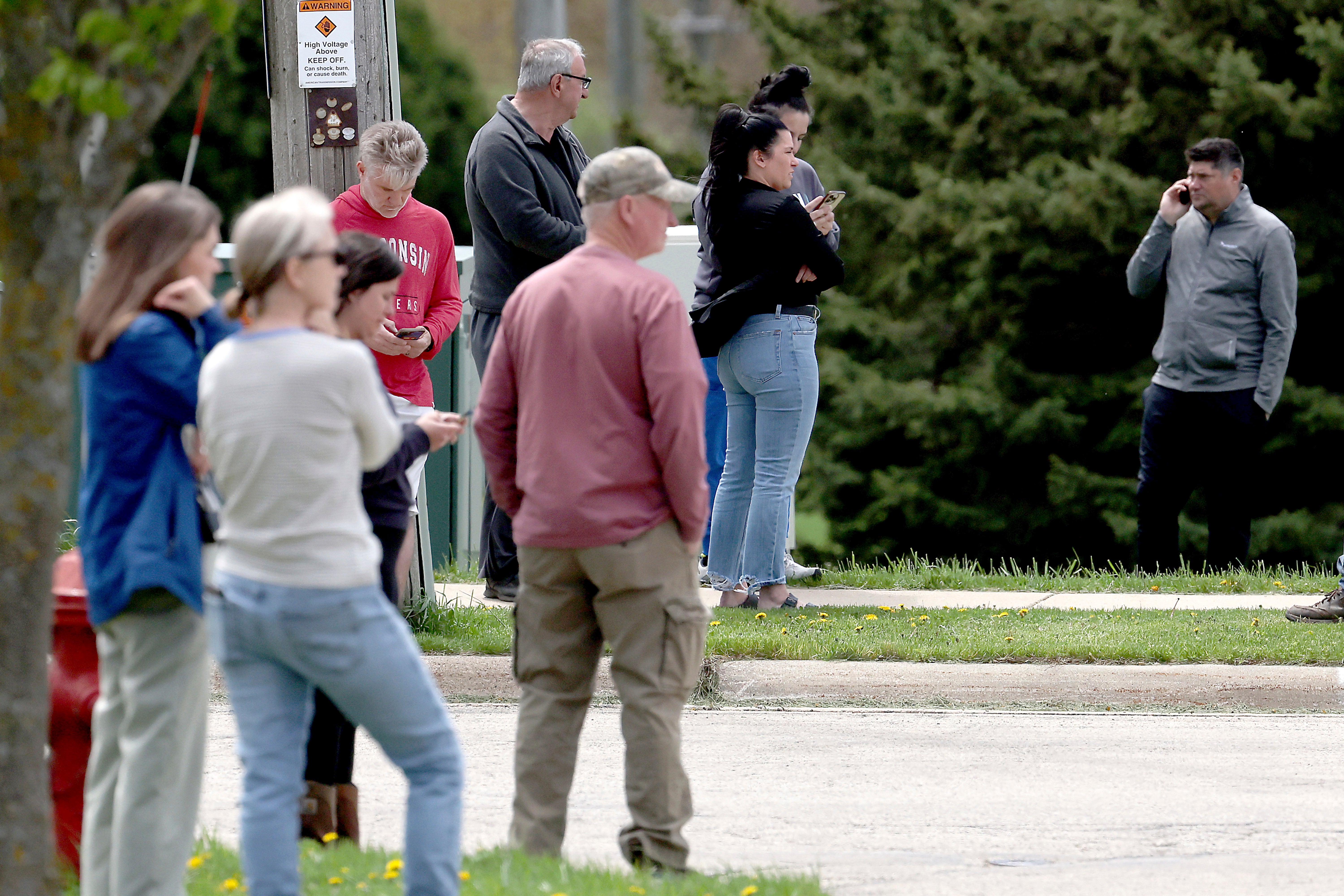 Family members wait as law enforcement personnel respond to the report of an active shooter at Mount Horeb Middle School in Mount Horeb, Wisconsin on Wednesday