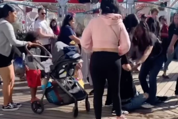 Footage online shows a group of three or four women, one of whom is pushing a stroller, punching and slapping a person on the ground while young children look on