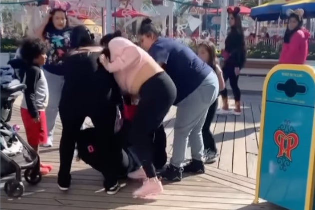 Young children look on as the savage incident unfolds close to the Pixar Pier attraction