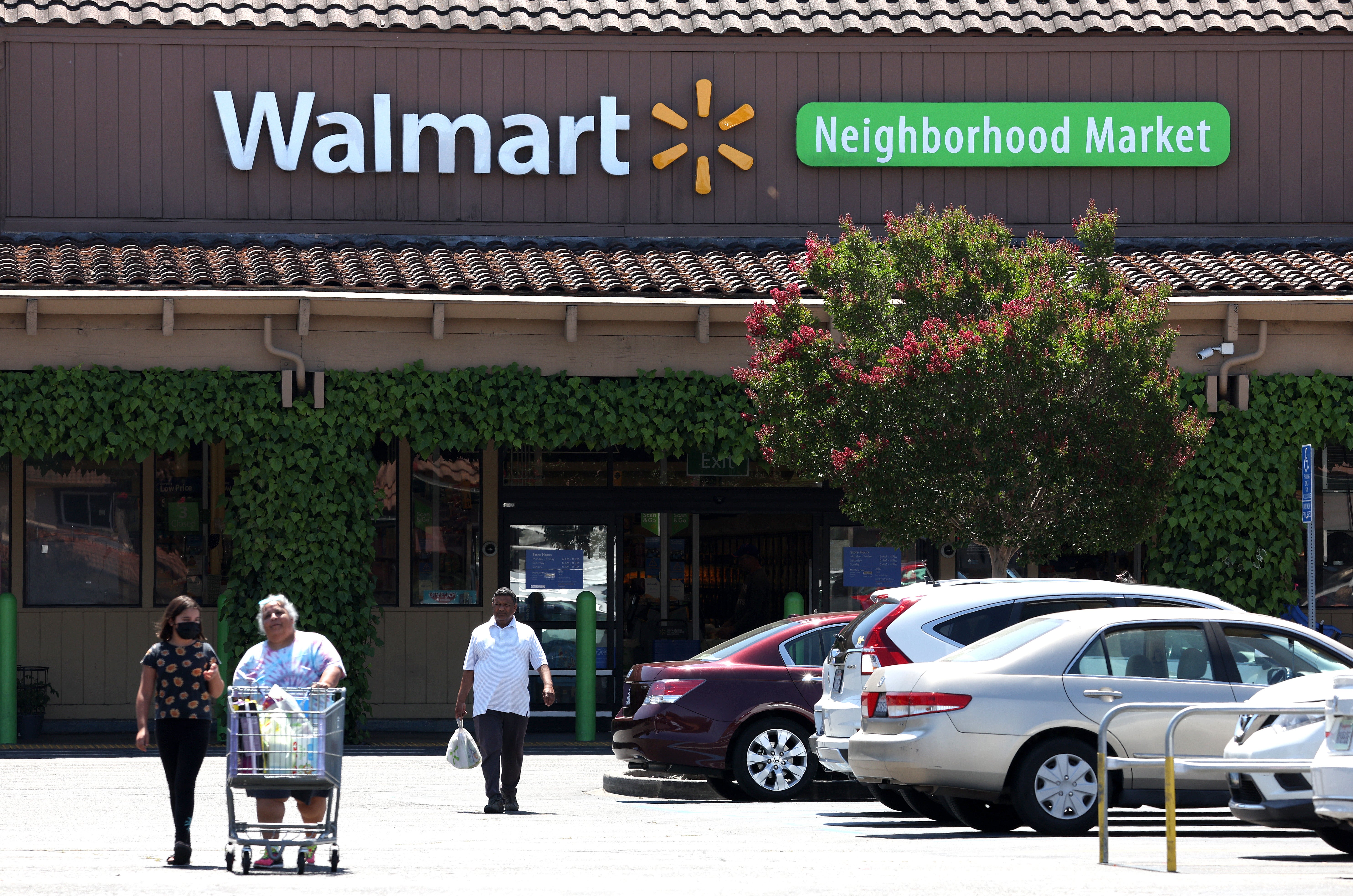 Customers leave a Walmart Neighborhood Market on August 04, 2022 in Rohnert Park, California