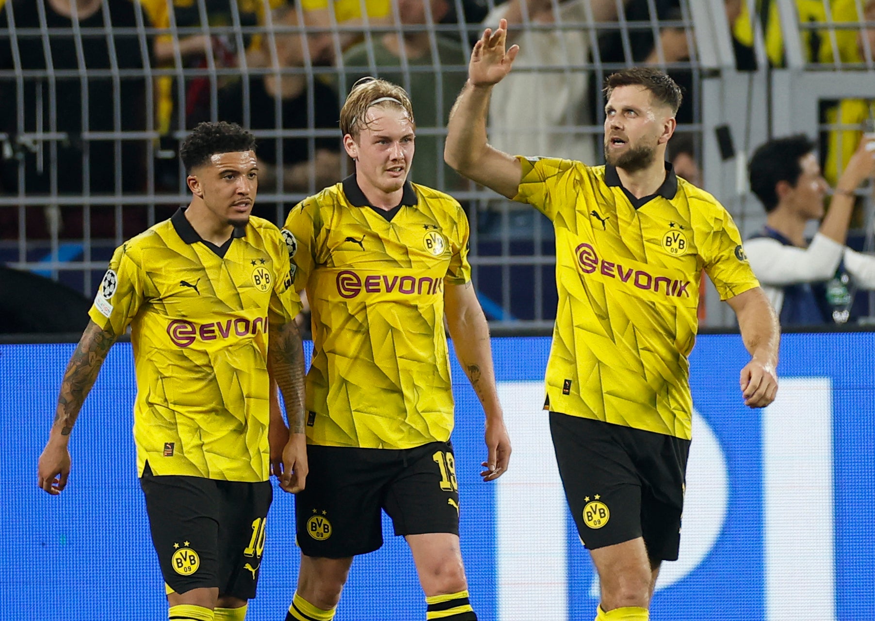 Jadon Sancho, left, Julian Brandt, centre, and Niclas Fullkrug, right, celebrate the win for Dortmund