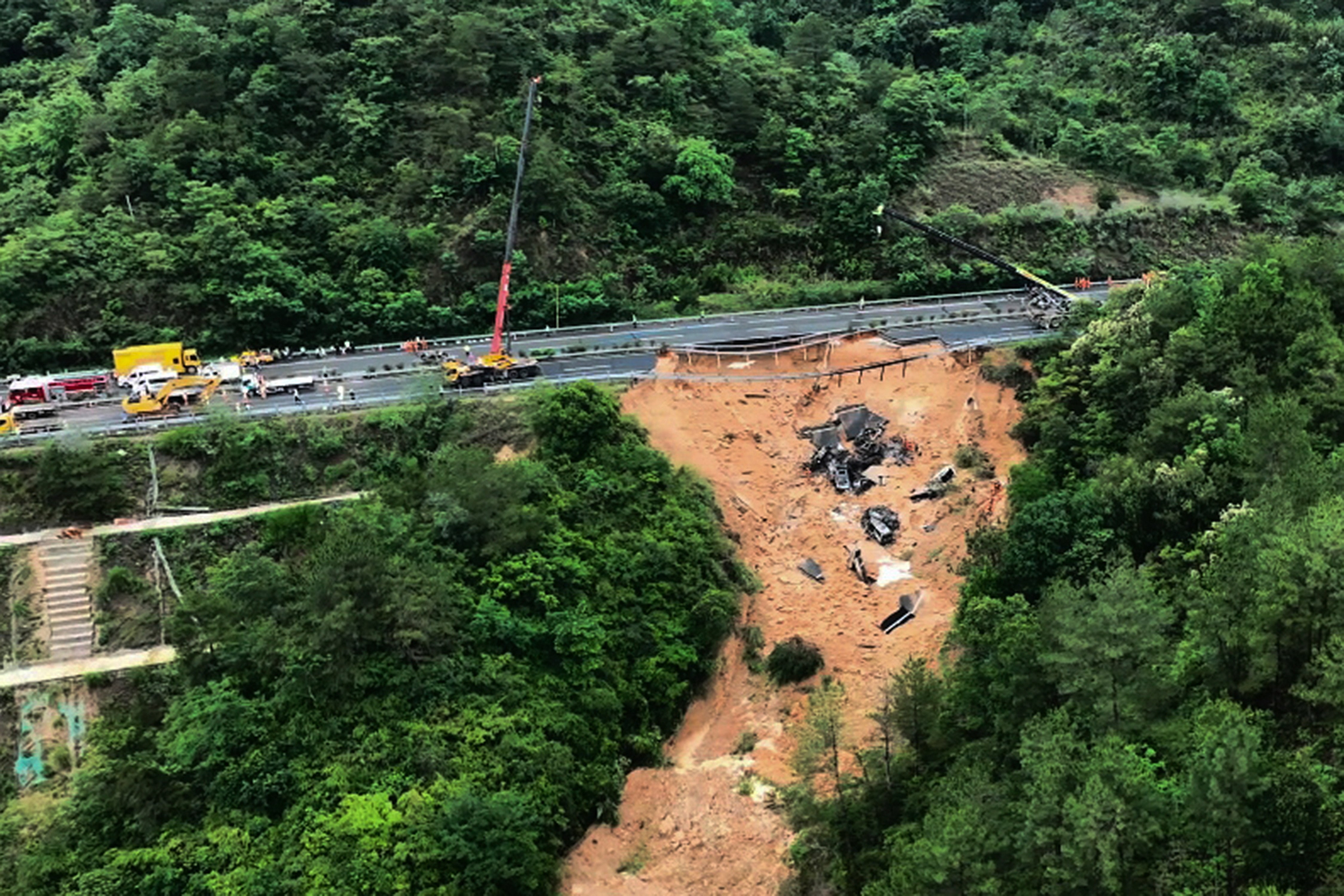 Rescuers working at the site of a collapsed road section of the Meizhou-Dabu Expressway in Meizhou