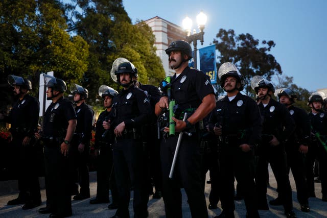 <p>Police officers get into position as pro-Palestinian students and activists demonstrate on the campus of the University of California, Los Angeles (UCLA) in Los Angeles, California, on 1 May 2024</p>