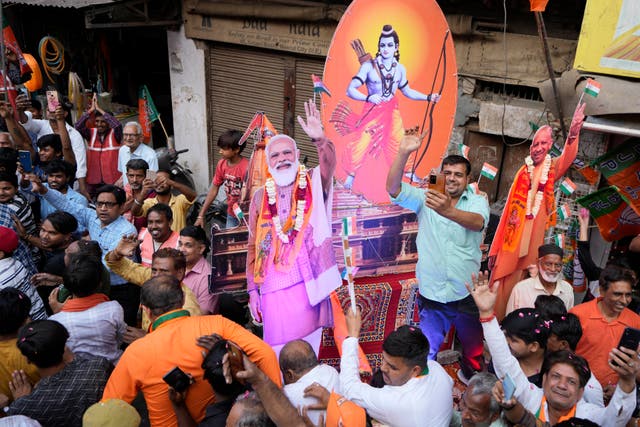 <p>Supporters of India’s ruling party campaign with an image of Hindu god Ram and photos of prime minister Narendra Modi</p>