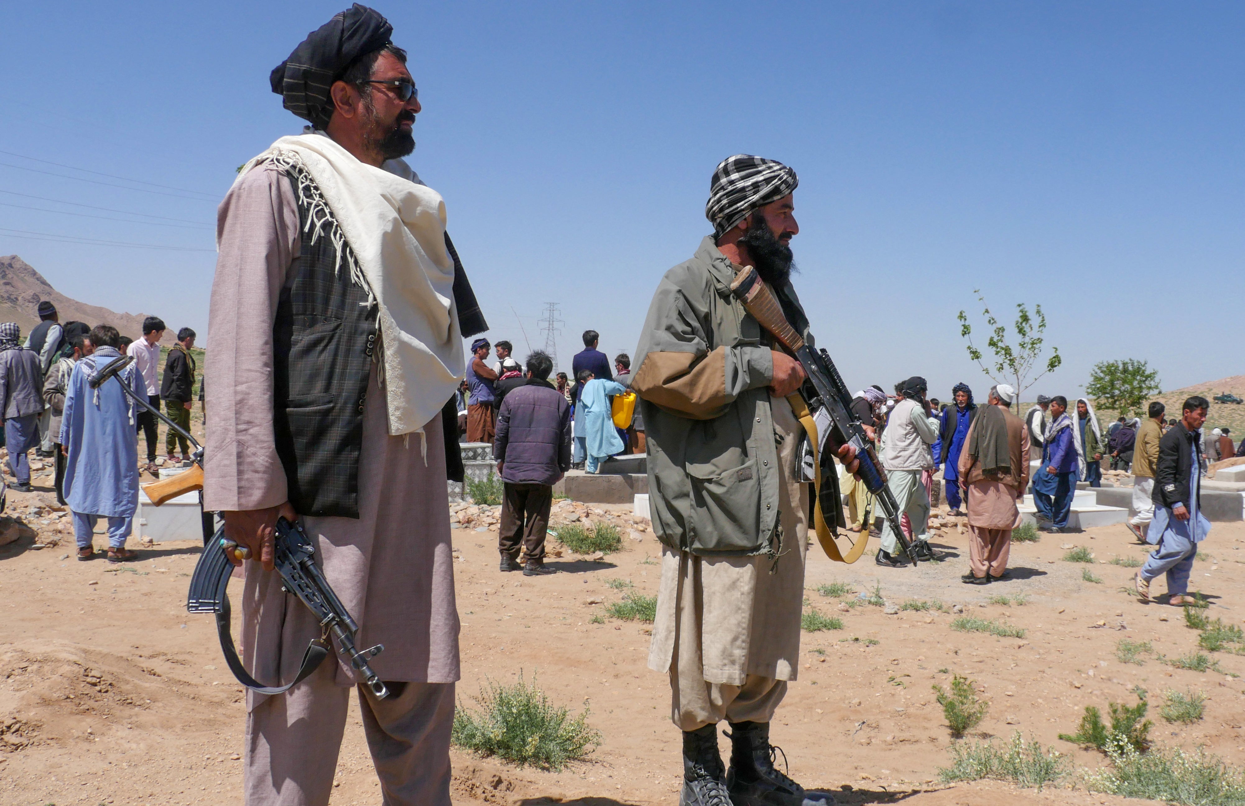 <p>Taliban security personnel stand guard as Afghans mourn at a burial ceremony of the slain Shiite Muslims after gunmen attacked a mosque in Guzara district of Herat </p>