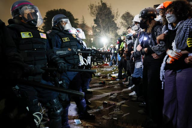 <p>Anti-war protesters at the University of California Los Angeles pictured facing off against police. Officers arrested more than 130 demonstrators on the campus </p>