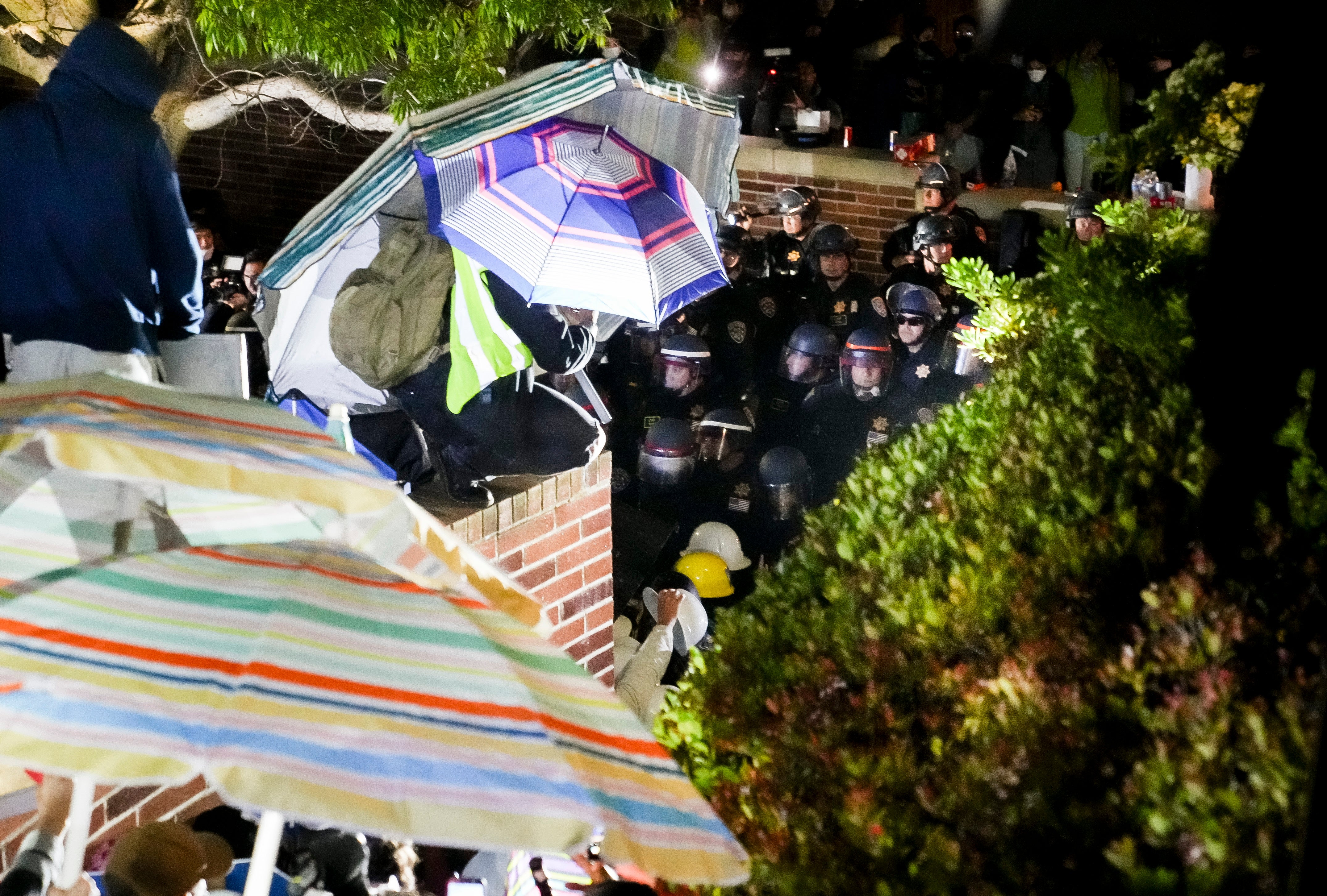 Demonstrators face off with police officers at the ongoing encampment of pro-Palestinian protesters on the campus of University of California Los Angeles
