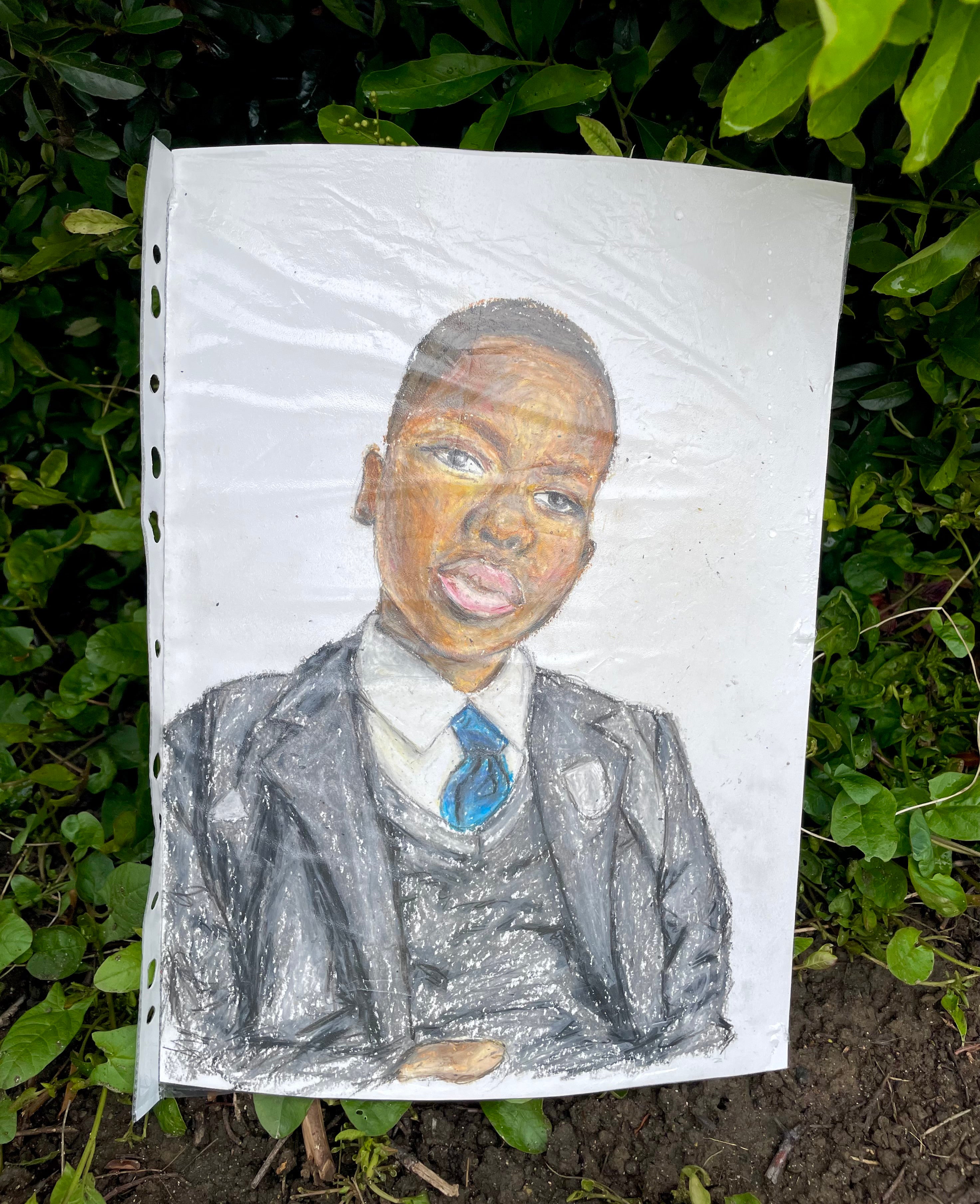 Artwork left with flowers near the scene in Hainault, north east London, where 14-year-old Daniel Anjorin was killed in a sword attack on Tuesday