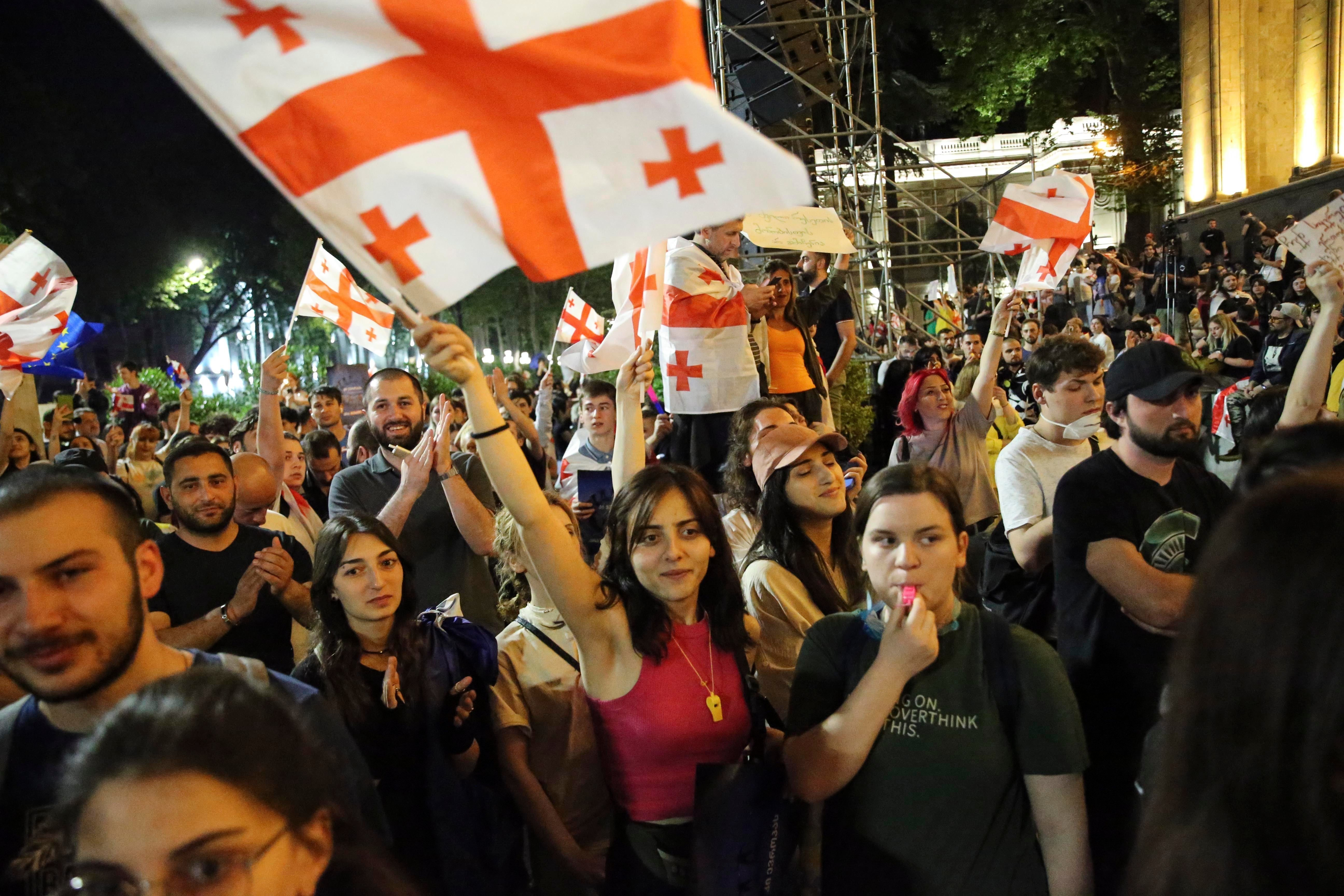 Demonstrators wave Georgia’s national flag in protest at the so-called ‘Russian law’