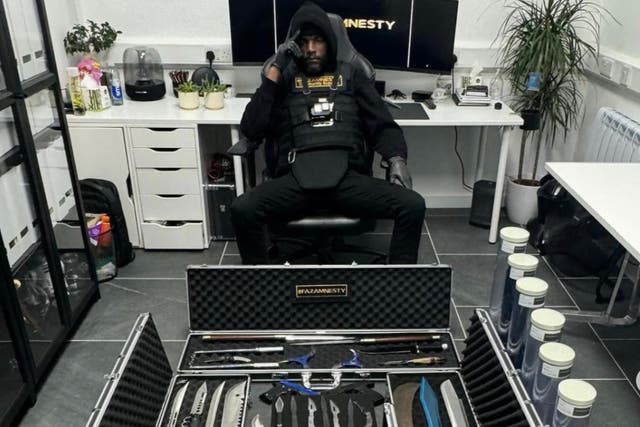 <p>Faron Paul in his office, wearing the stab-proof vest he wears for knife pick ups  </p>