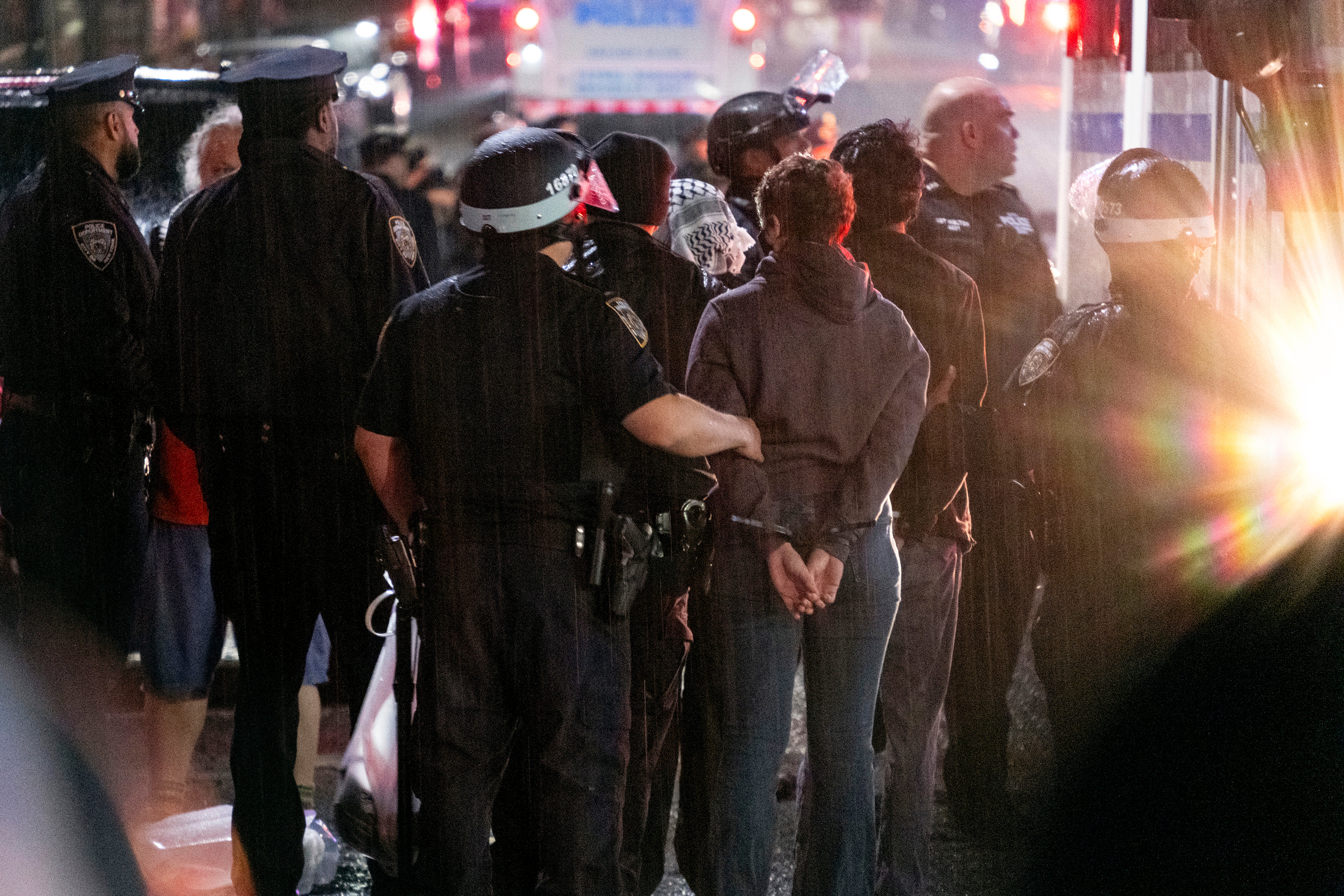 New York City police officers take people into custody near the Columbia University campus in New York on 30 April