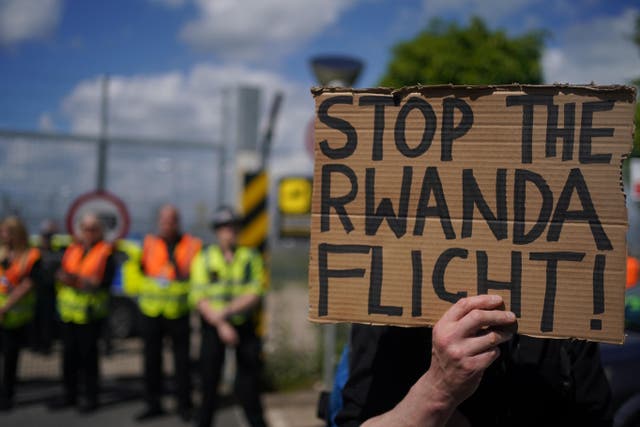 <p>Demonstrators at a removal centre at Gatwick protest against plans to send migrants to Rwanda (PA)</p>