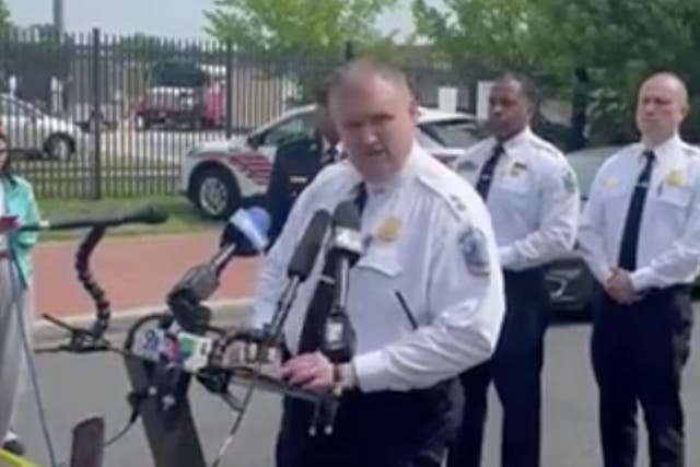 <p>Police officers give an press conference after a 17-year-old girl was ‘grazed’ by a bullet after being caught in the crossfire of a shooting near a high school in Washington DC on Friday morning</p>