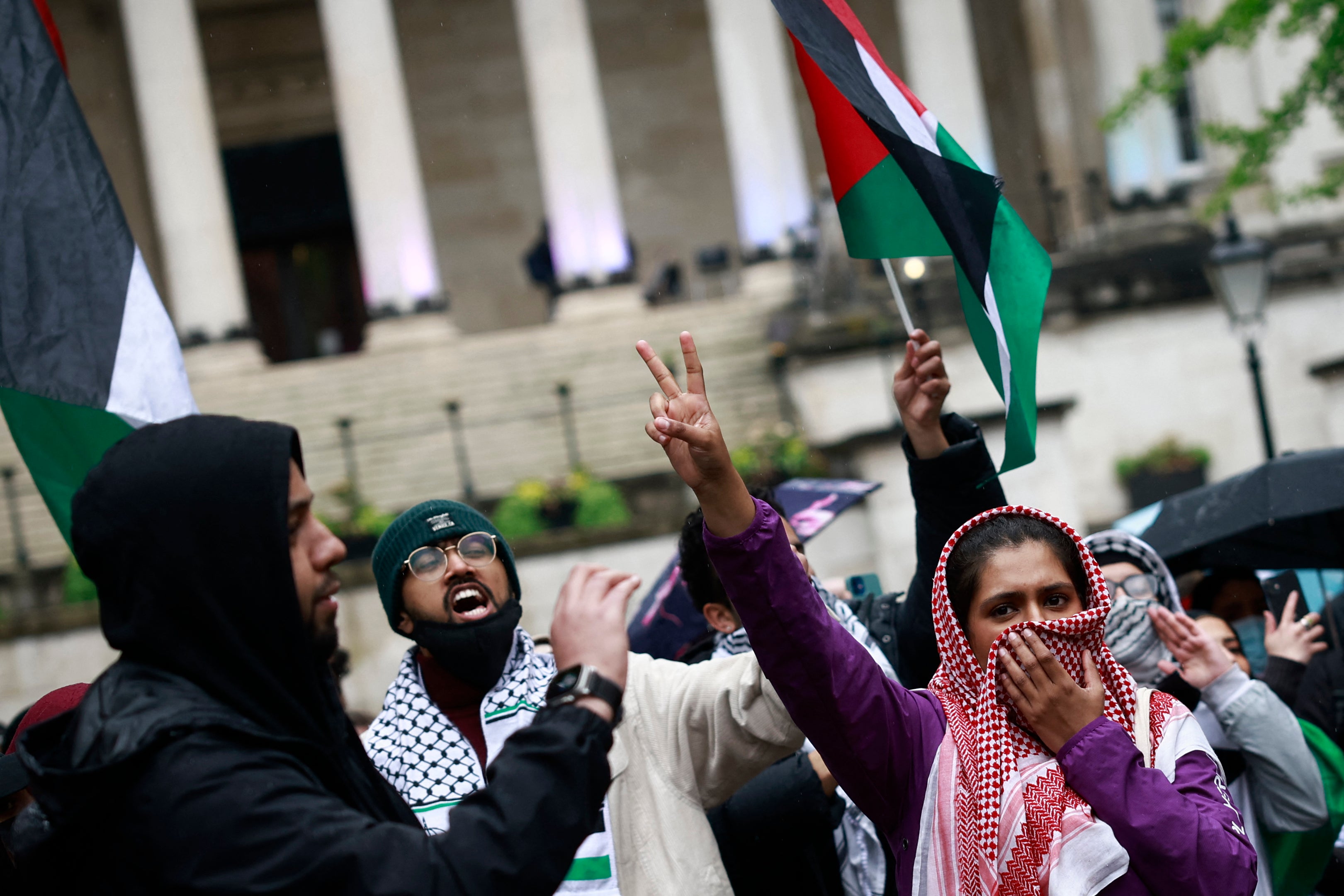 Students waving the Palestinian flag take part in a demonstration in support to Palestinian people at University College London