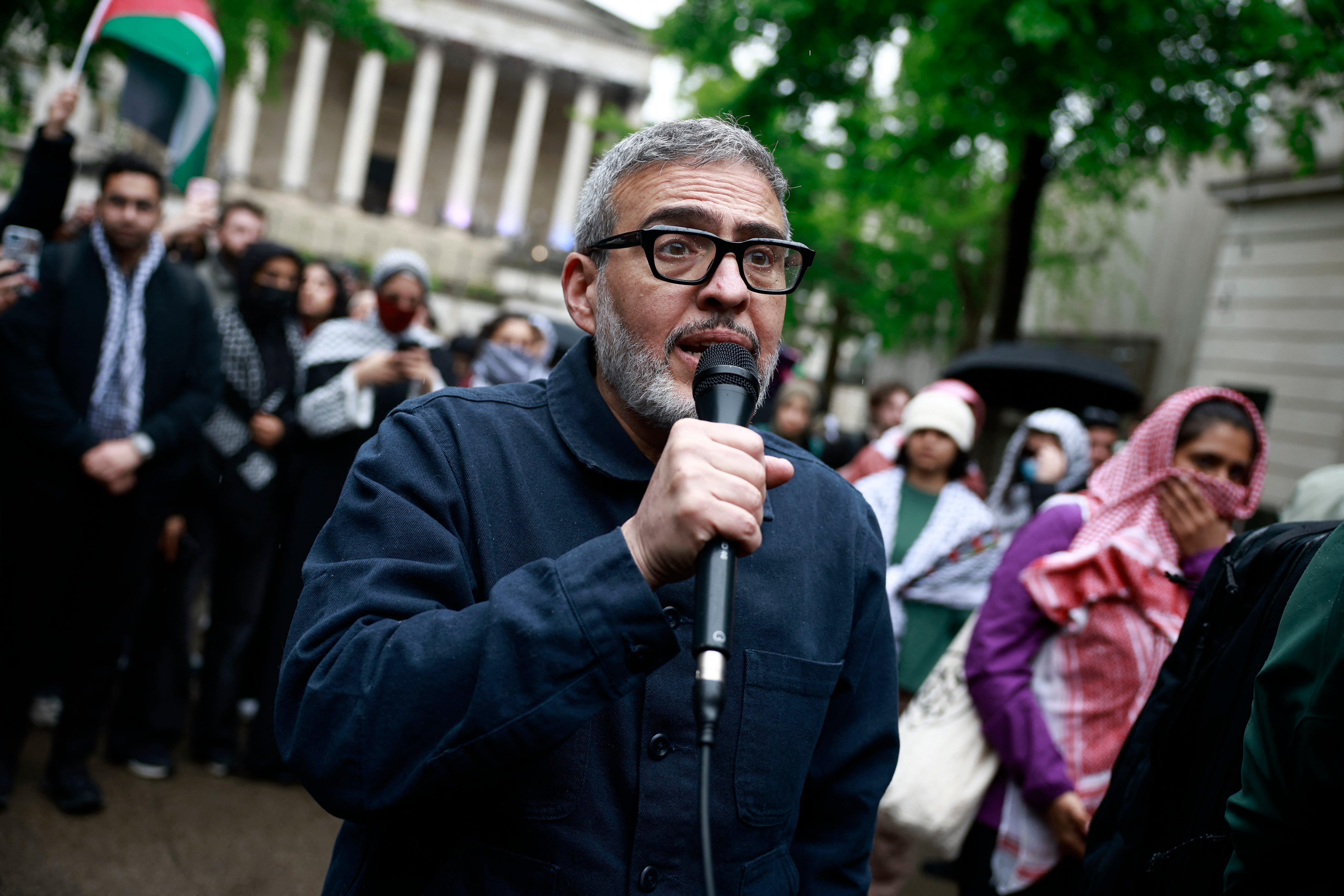 British-Palestinian plastic surgeon specialising in conflict injuries Ghassan Abu Sitta speaks to the press during a demonstration in support to Palestinian people at University College London (UCL) main entrance