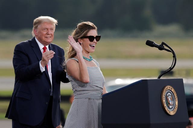 <p>Hope Hicks waves near then-president Donald Trump during a campaign rally on 16 October 2020</p>