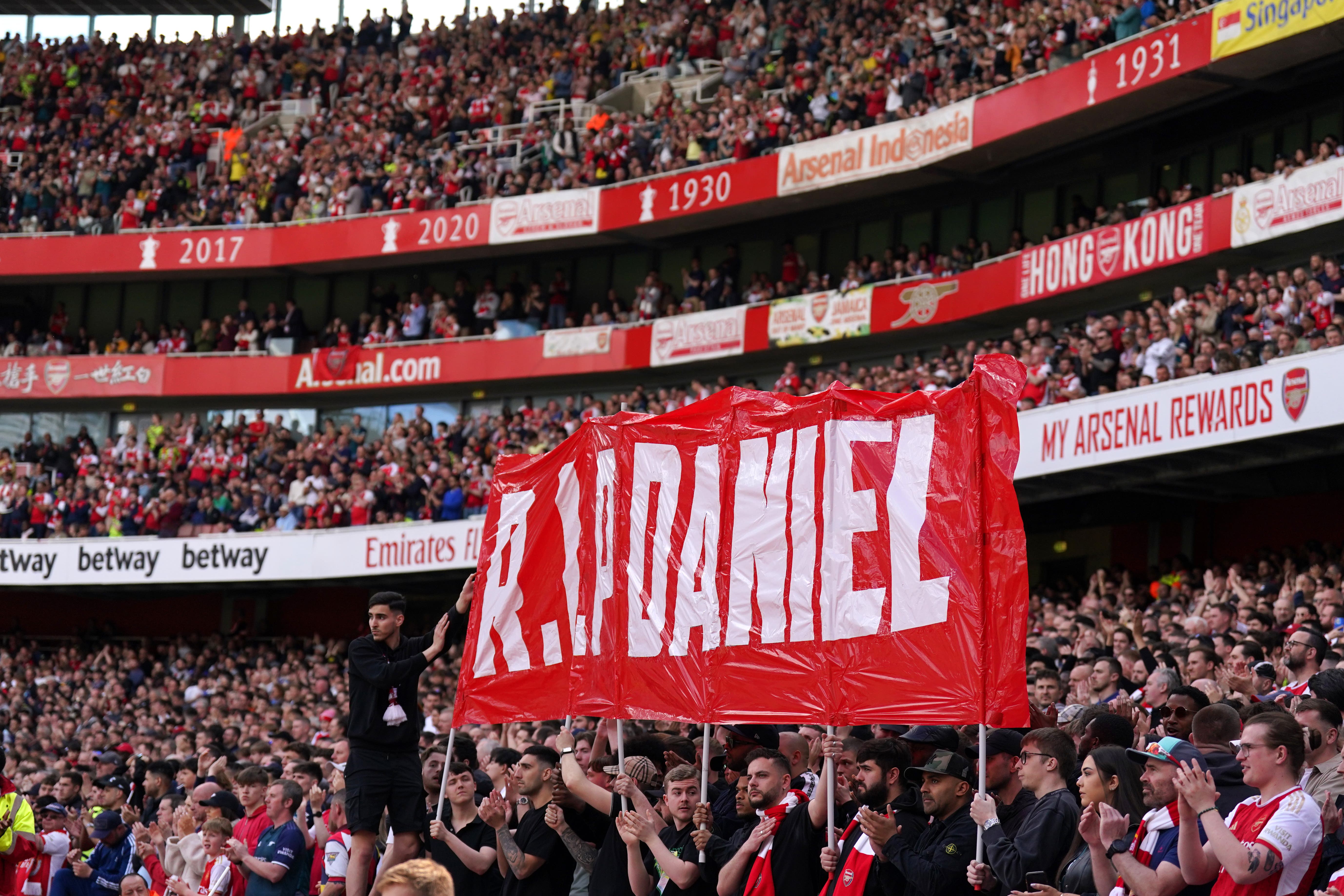 Fans hold up a banner on the 14th minute during Arsenal’s Premier League match against Bournemouth in memory of the 14-year-old