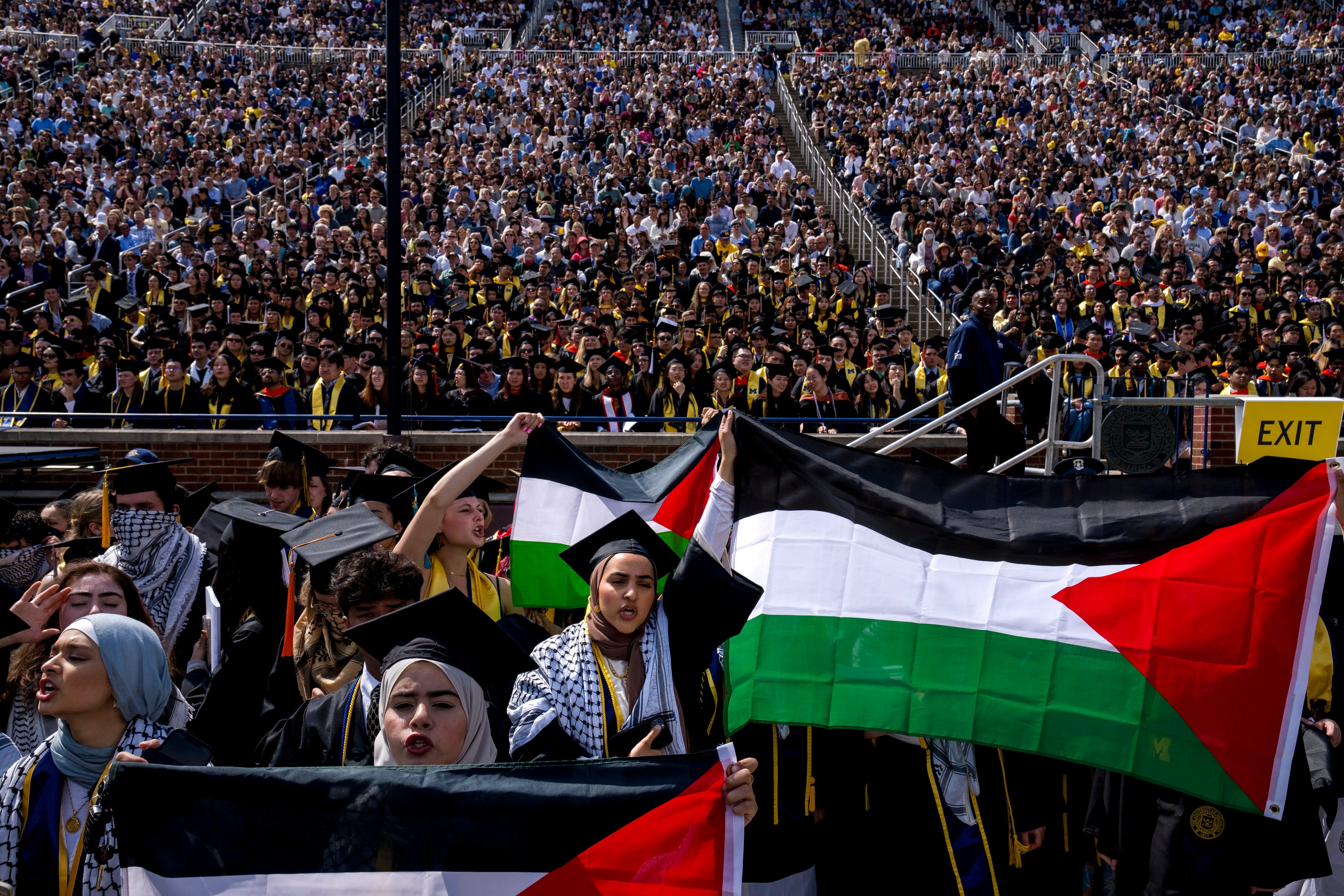 Salma Hamamy, center, holds a Flag of Palestine during a Pro-Palestinian protest during the University of Michigan's spring commencement ceremony