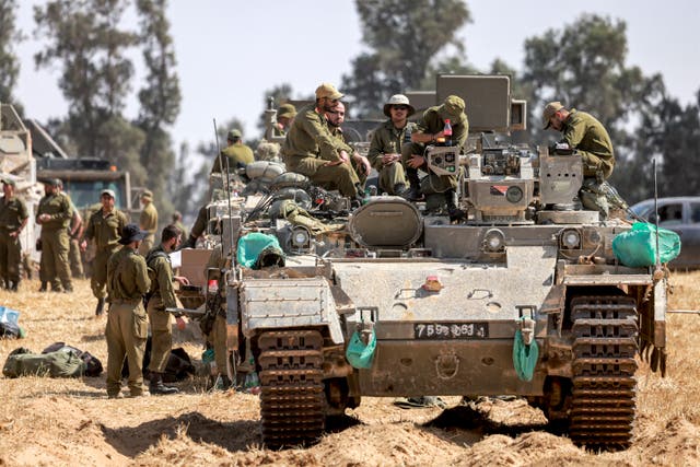 <p>Israeli army soldiers sit atop an infantry-fighting vehicle (IFV) positioned near the border with the Gaza strip in southern Israel on April 30, 2024</p>