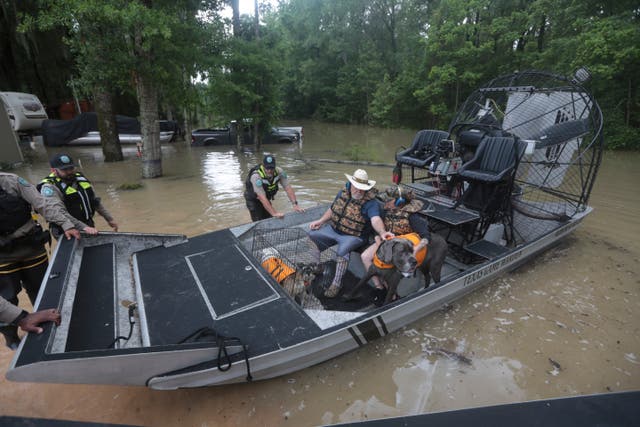 <p>Texas Parks & Wildlife Department game wardens use a boat to rescue residents from floodwaters in Liberty County, Texas, on Saturday </p>