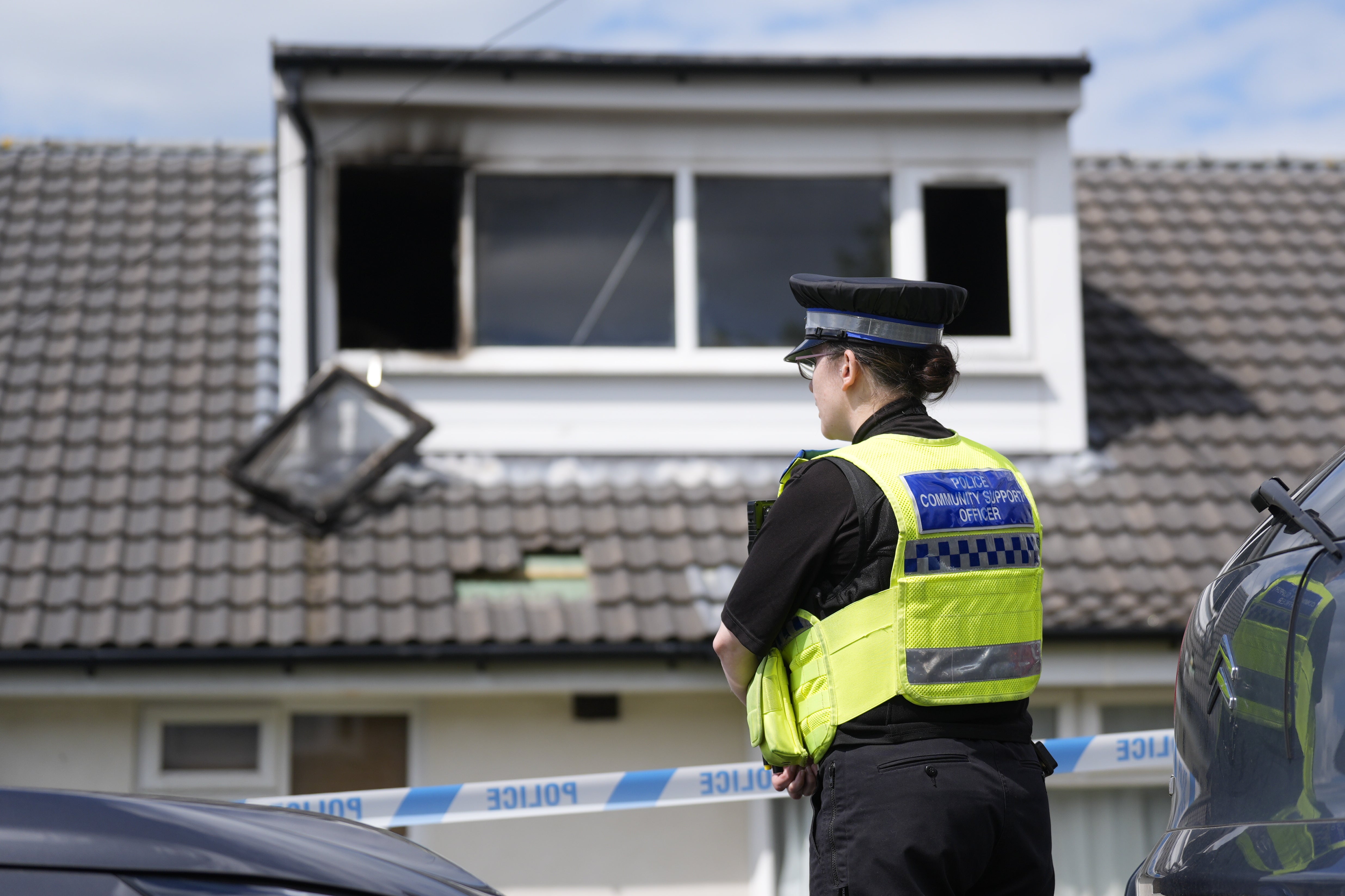 A police officer at the scene of a fatal house fire in Bradford