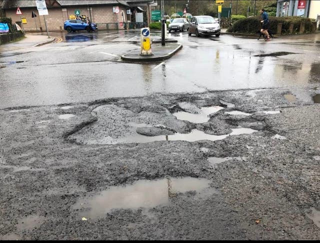 <p>A large pothole in Totnes, Devon, became a listed tourist attraction on TripAdvisor</p>