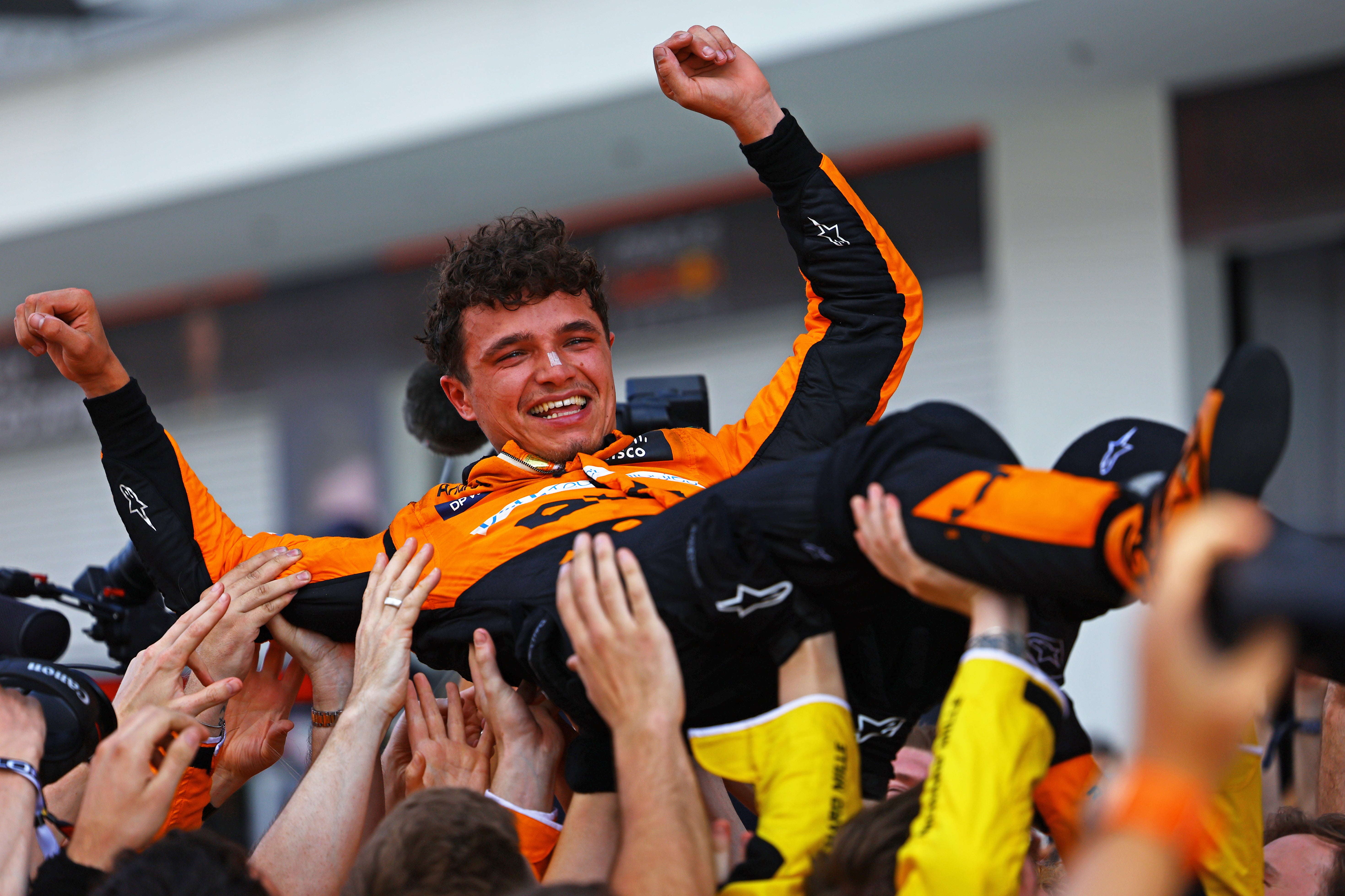 Norris celebrates after the grand prix with his McLaren team