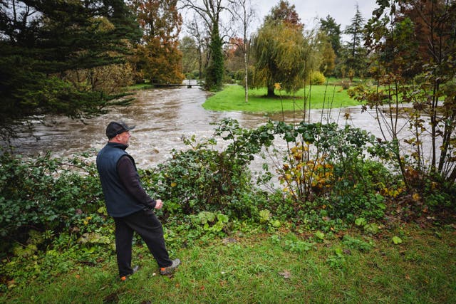 <p>A farm owner looks at the rising water of the River Test in November 2023 as strong winds and heavy rain from Storm Ciaran hit Britain. This winter has been confirmed as eighth wettest on record, causing widespread flooding across the country, including farmland. </p>