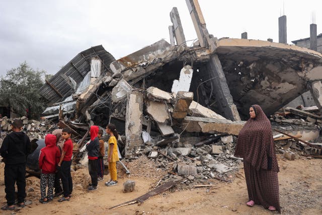 <p>Palestinians inspect the destruction following overnight Israeli strikes on Rafah in the southern Gaza Strip on 6 May</p>