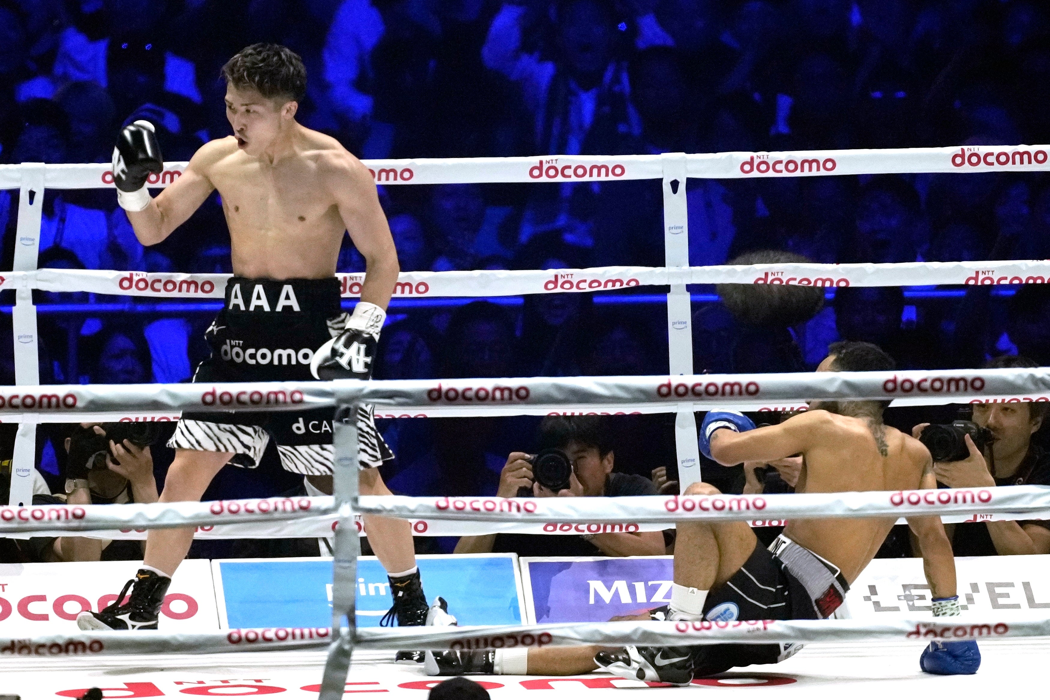 Naoya Inoue (left) recovered from a shock knockdown to beat Luis Nery in May