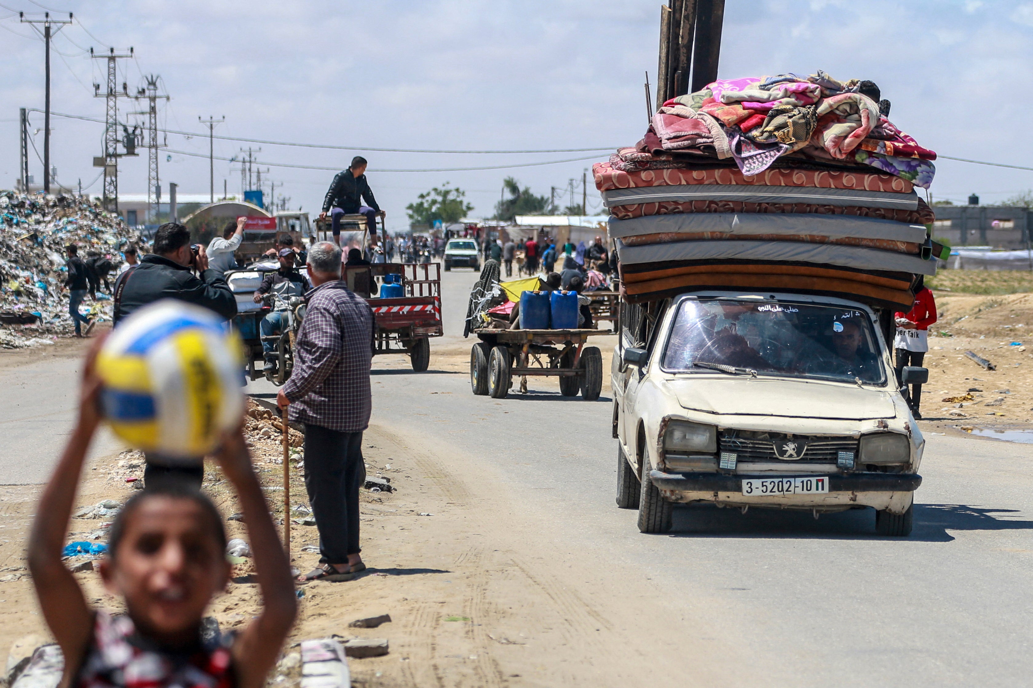Palestinians flee Rafah with mattresses and blankets ahead of a long-anticipated Israeli invasion of the area