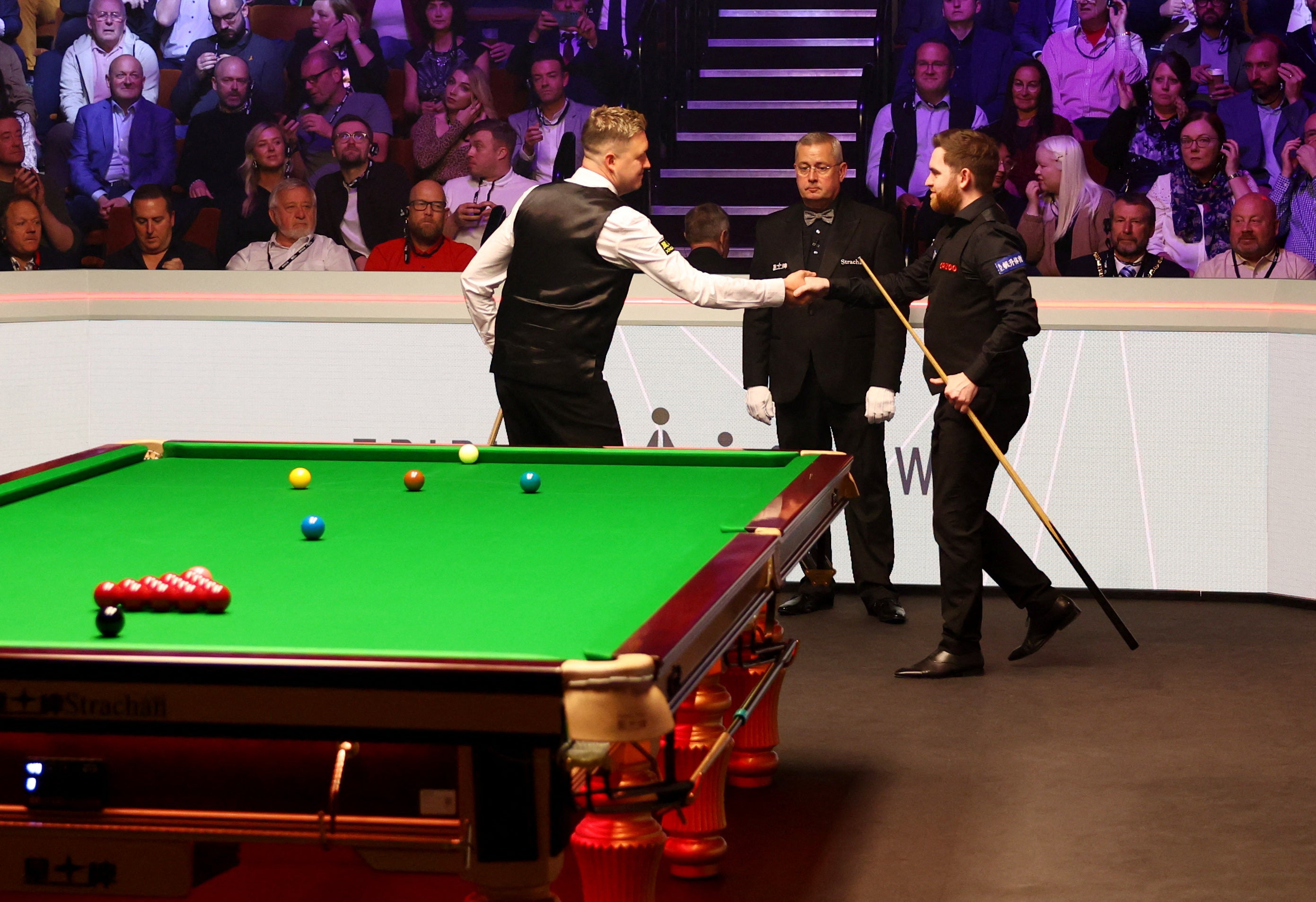 Kyren Wilson and Jak Jones shake hands before the evening session