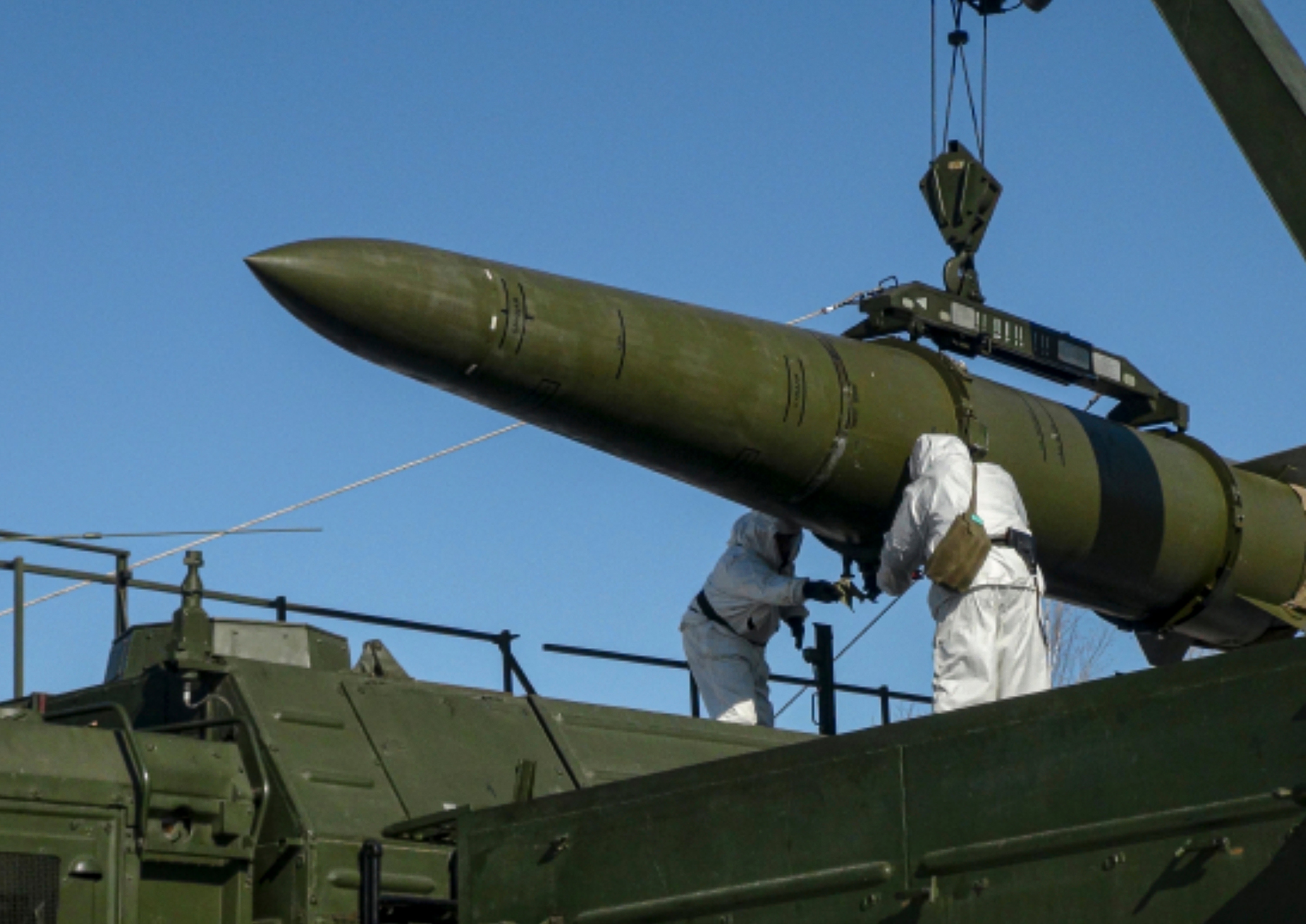 Russian troops load an Iskander ballistic missile onto a mobile launcher in February