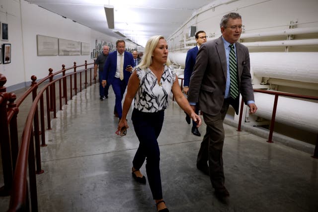 <p>Marjorie Taylor Greene and Thomas Massie walk through the US Capitol to Speaker Mike Johnson’s office on 6 May 2024. Ms Greene is meeting with Mr Johnson on Monday afternoon about her efforts to oust him</p>