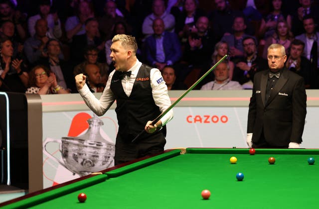 <p>Kyren Wilson celebrates after clinching his first world title</p>