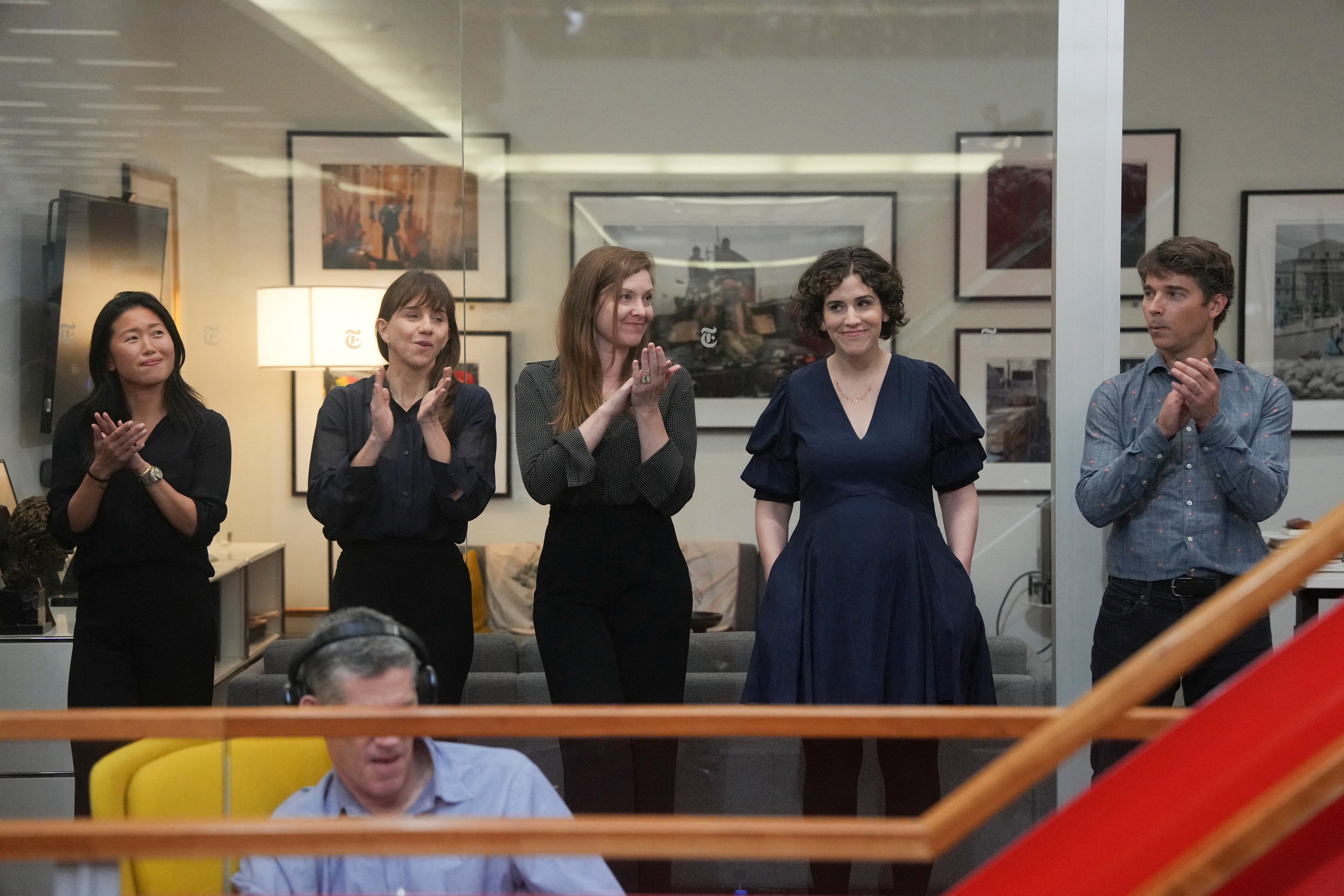 Hannah Dreier (second from right) reacts as colleagues applaud during a Pulitzer Prize gathering in the newsroom of The New York Times in New York City