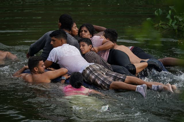 <p>Migrants cross the Rio Bravo on an inflatable mattress into the United States from Matamoros, Mexico, on May 9, 2023</p>