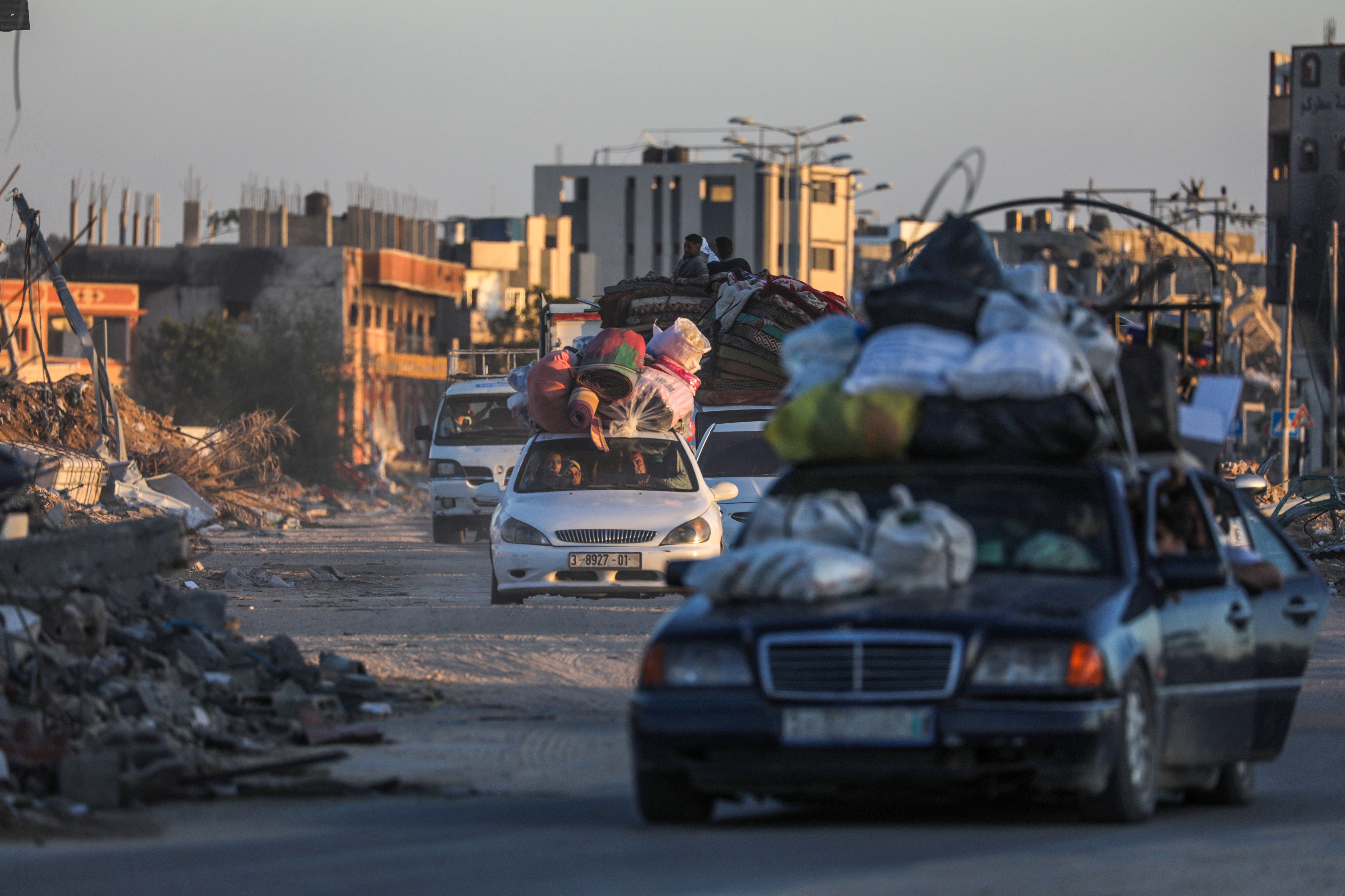 Dozens of cars leave the southern Gaza city of Rafah as Israel begins its offensive in the area