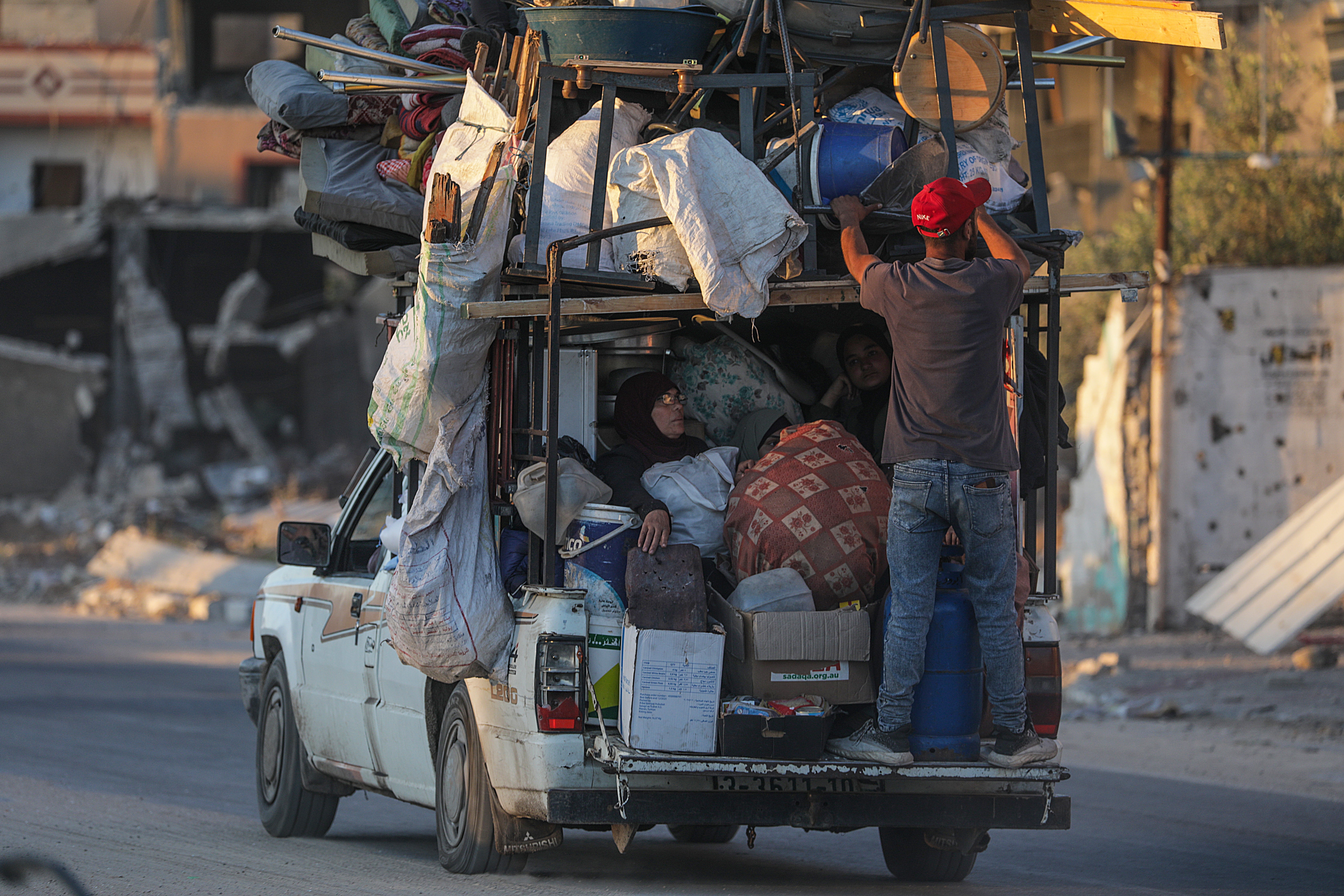 Civilians in Rafah load up a pick-up truck with essentials after Israel issues evacuation orders