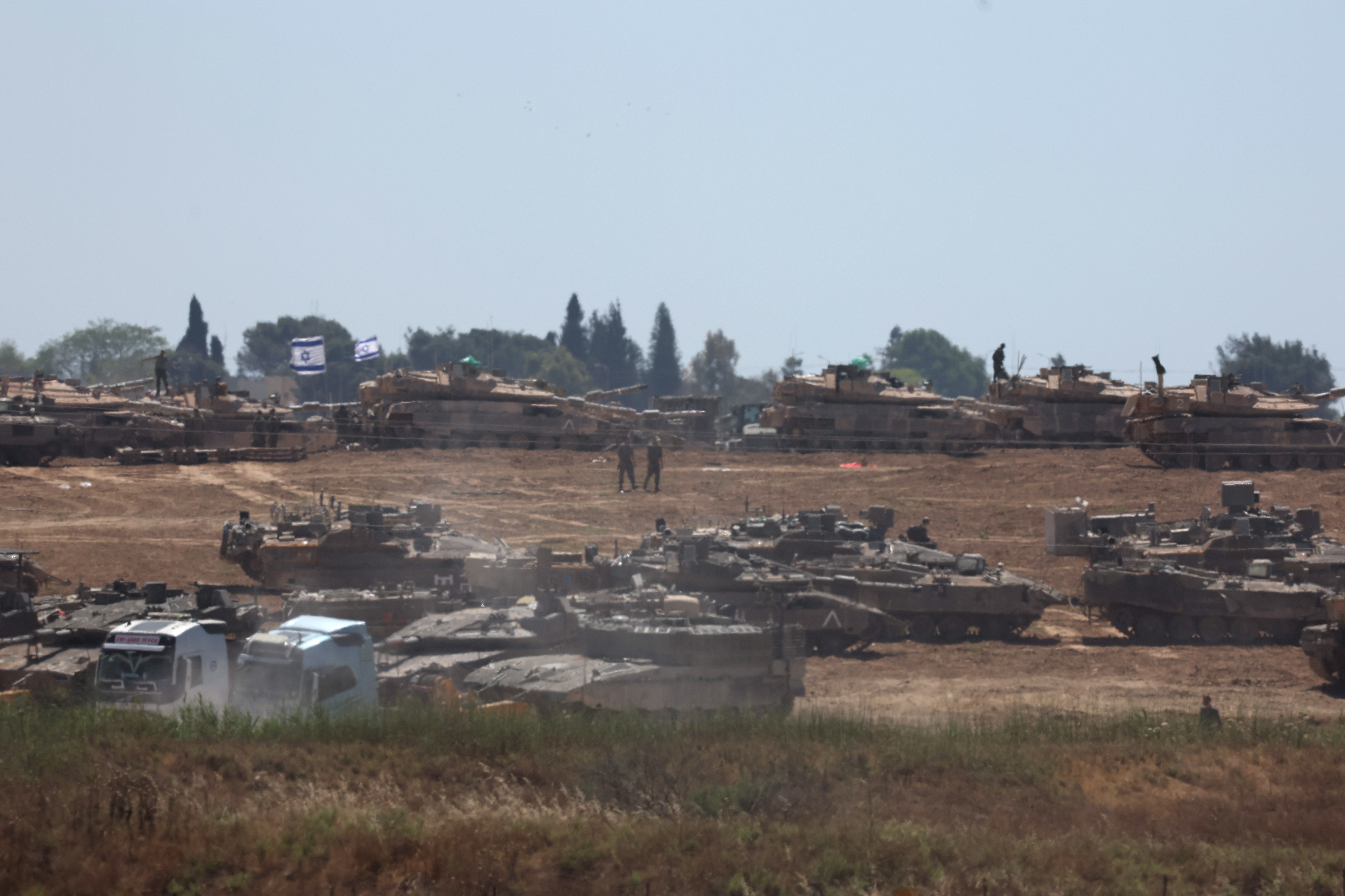 Israeli troops gather at an undisclosed location near the border with the Gaza Strip, in Israel