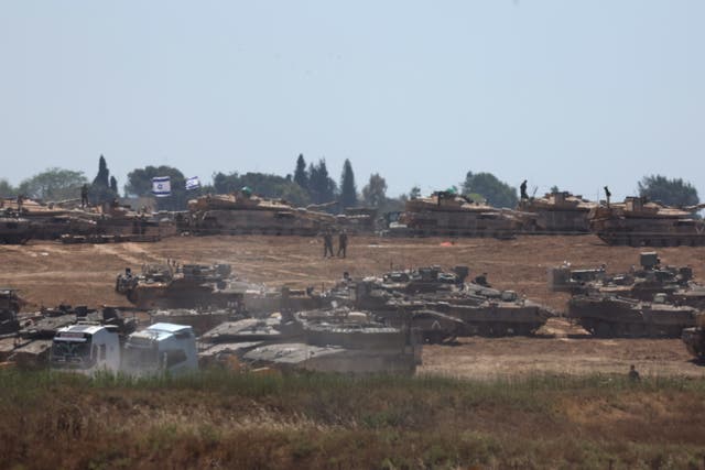 <p>Israeli troops gather at an undisclosed location near the border with the Gaza Strip, in Israel</p>
