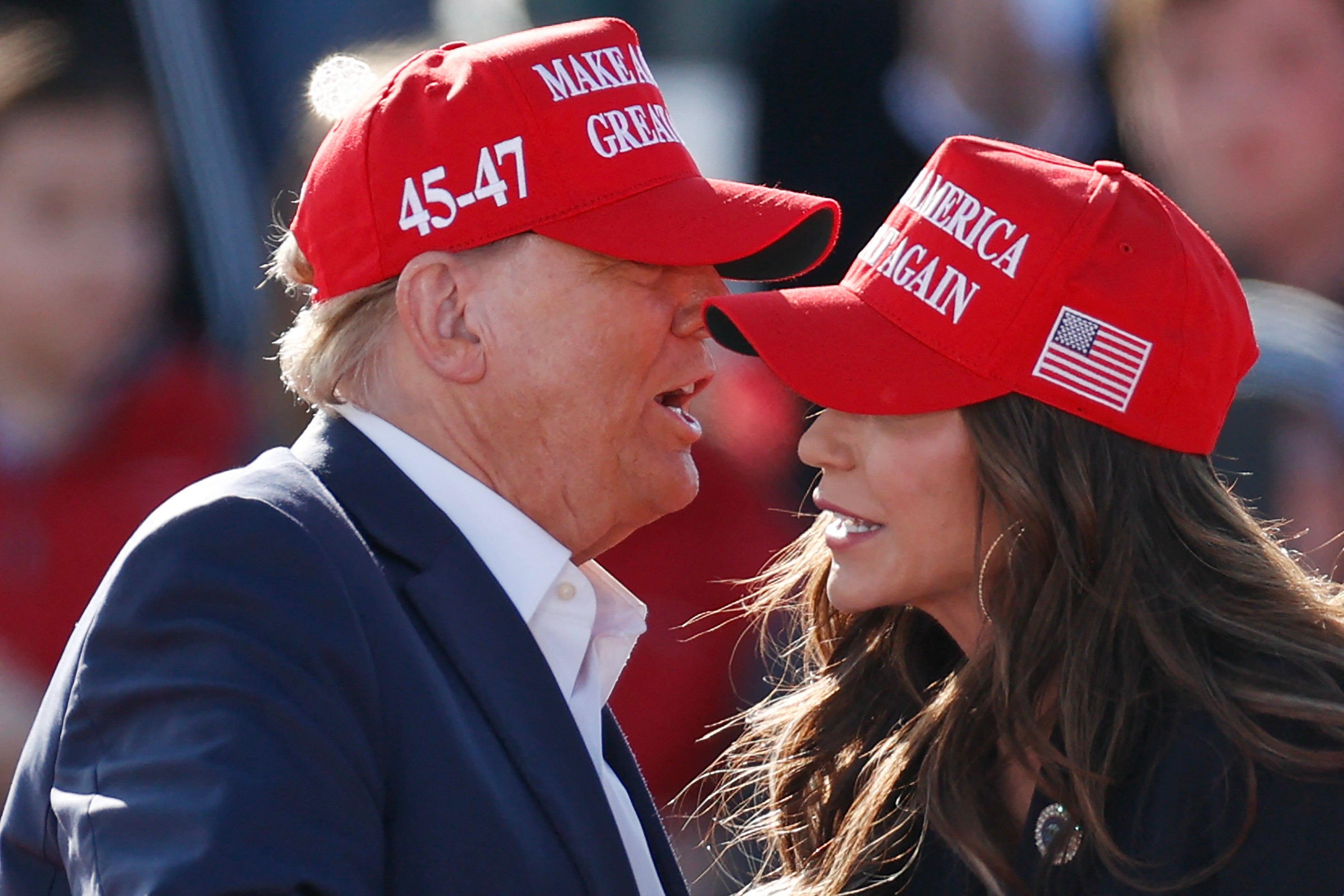 Donald Trump (left) speaks to Kristi Noem (right) at an Ohio campaign rally in March 2024