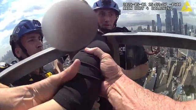 <p>Heart-stopping moment NYPD scale side of skyscraper to rescue woman 54-stories in air.</p>