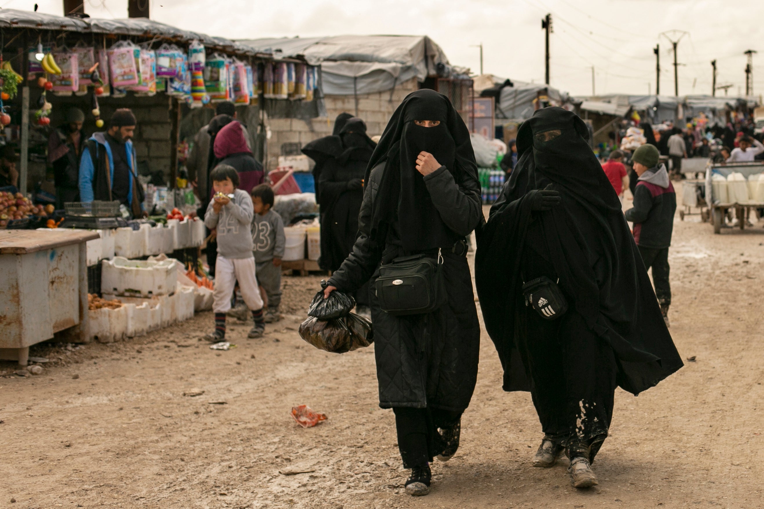 Two women are pictured in the Al Hol refugee camp in Syria