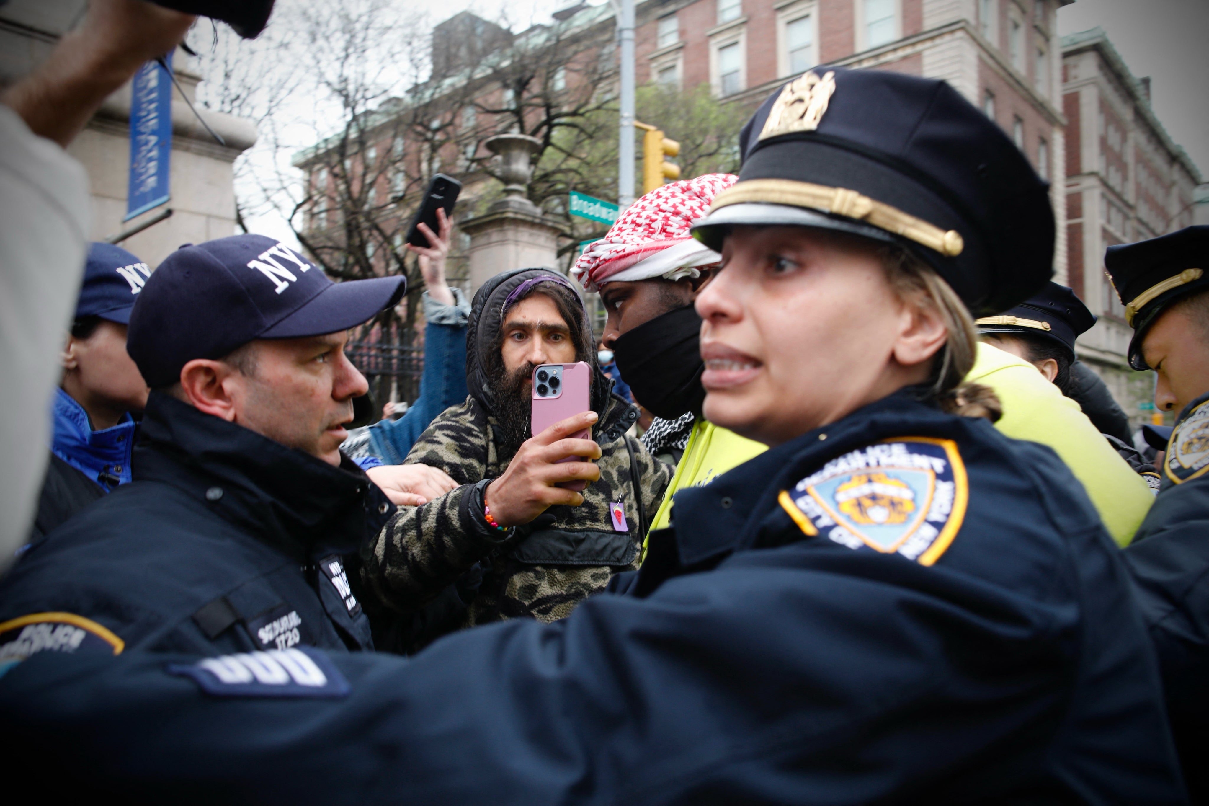 NYPD officers detain a person as pro-Palestinian protesters gather outside of Columbia University in New York City on April 18, 2024