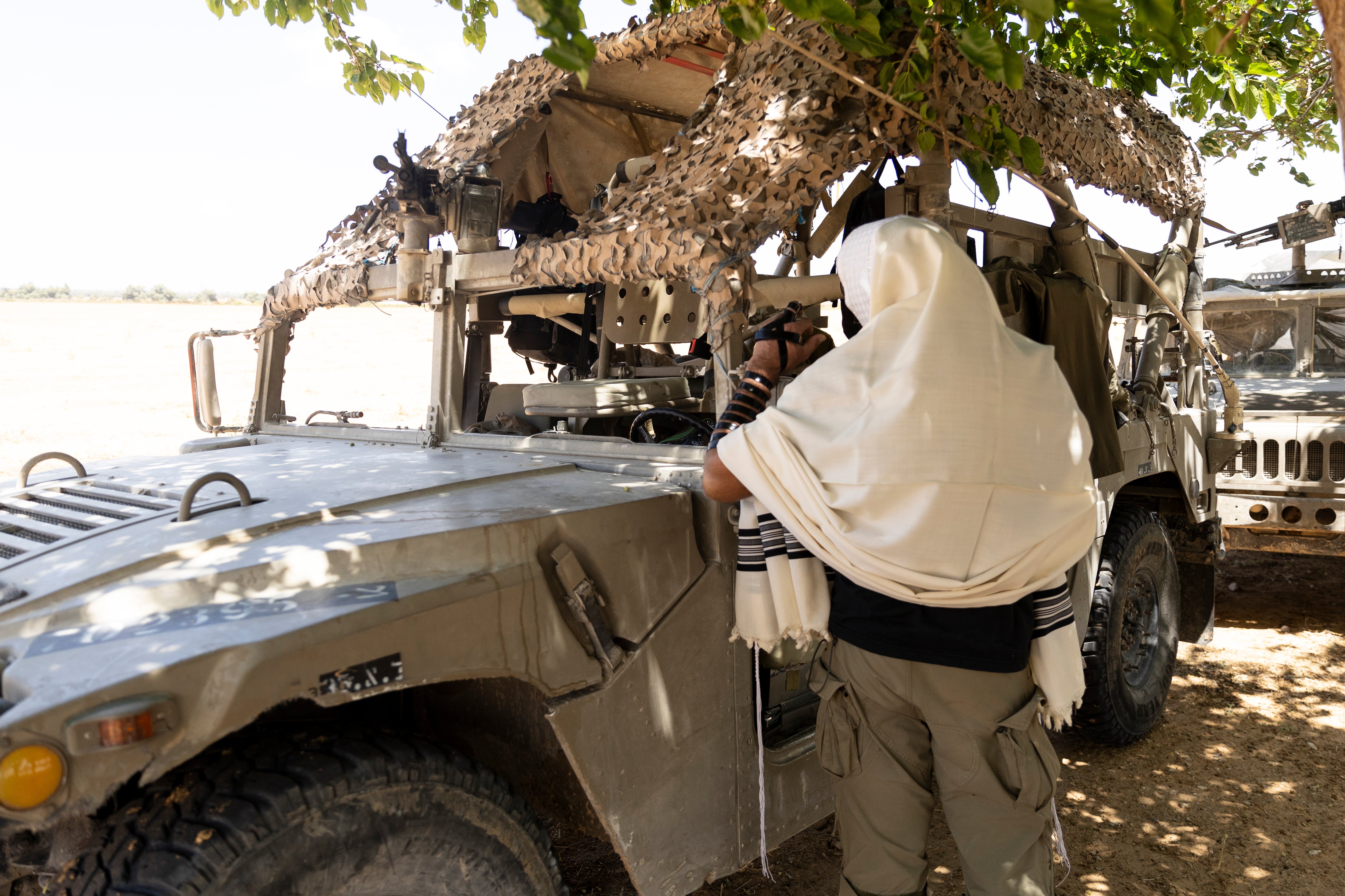 An Israeli soldier prays near an army vehicle near the border with the southern Gaza Strip on 7 May 2024 in Southern Israel