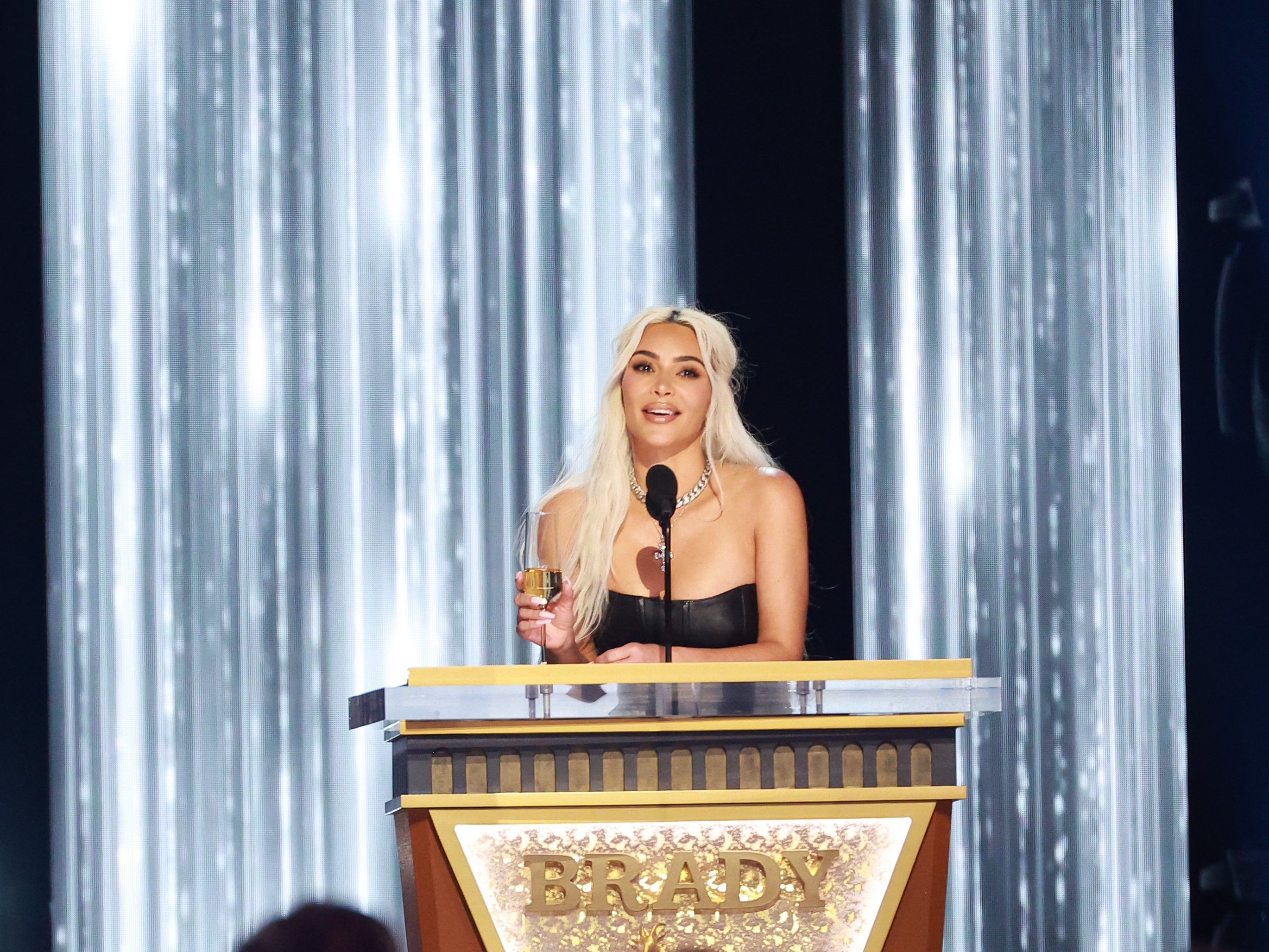 <p>Kim Kardashian speaks onstage during Tom Brady’s roast</p>